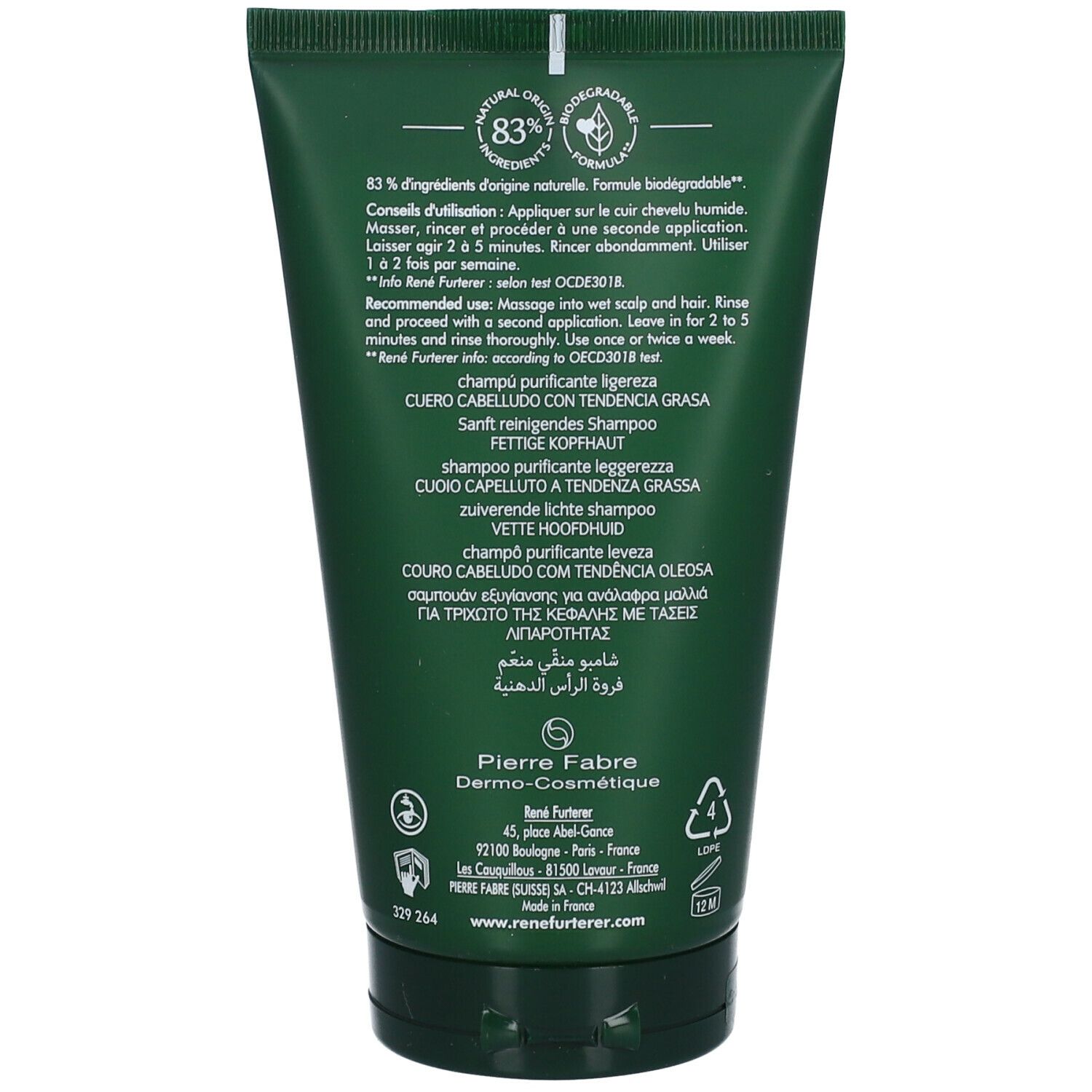 Achterkant van de groene shampoo tube. Meertalige tekst. 83% ingrediënten van natuurlijke oorsprong. Gebruiksinformatie.