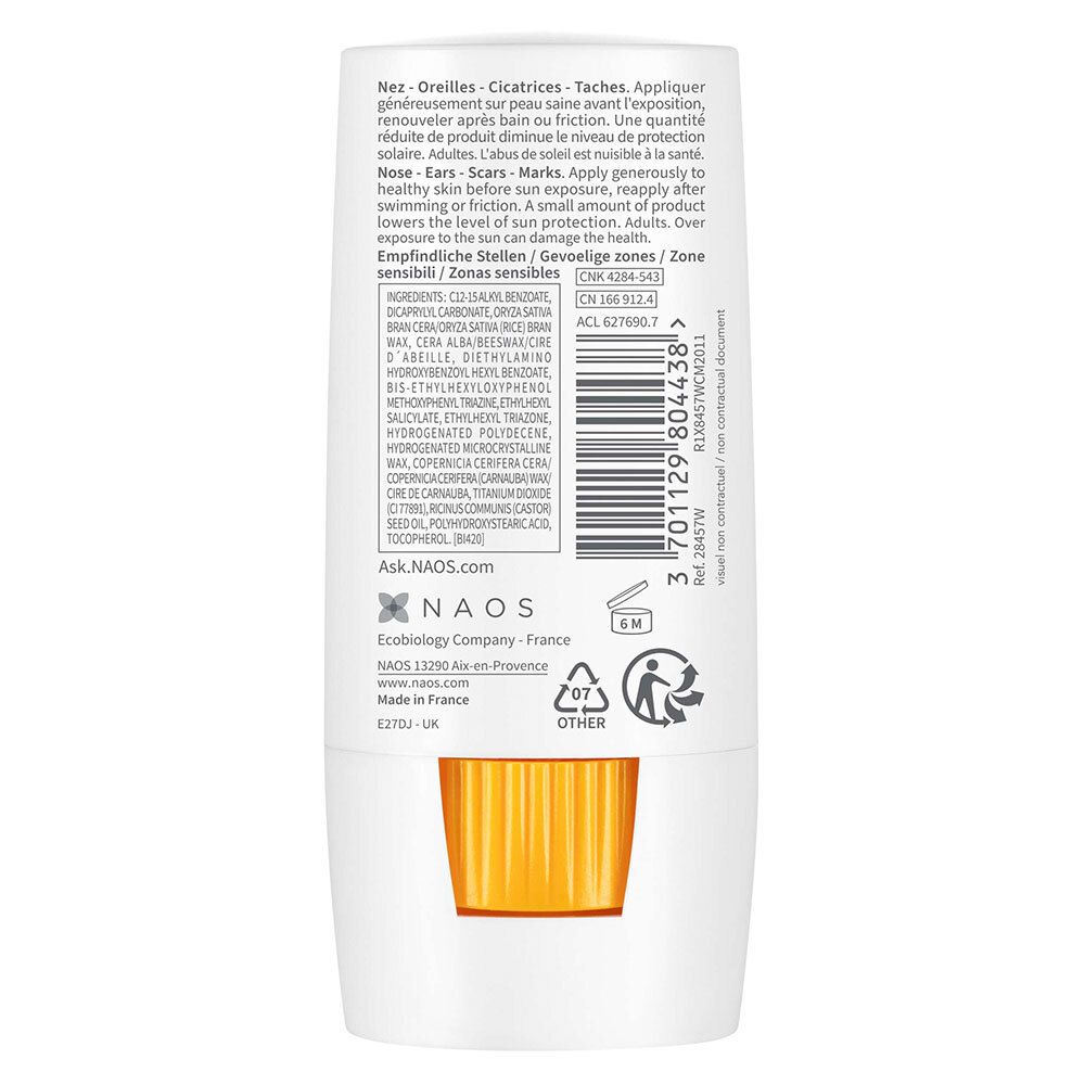 Dos du stick blanc. Contient des informations sur les ingrédients et l'utilisation. Applicateur jaune.