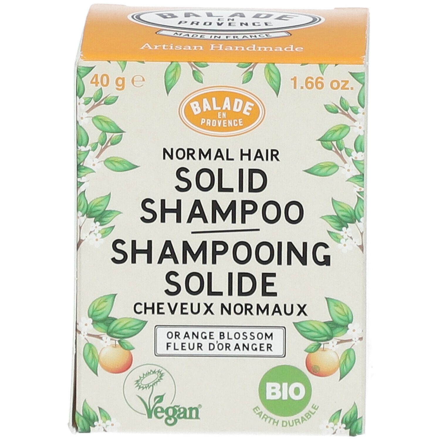 Voorkant van de shampoo verpakking. Productnaam, logo en Bio certificering. Oranje doos.