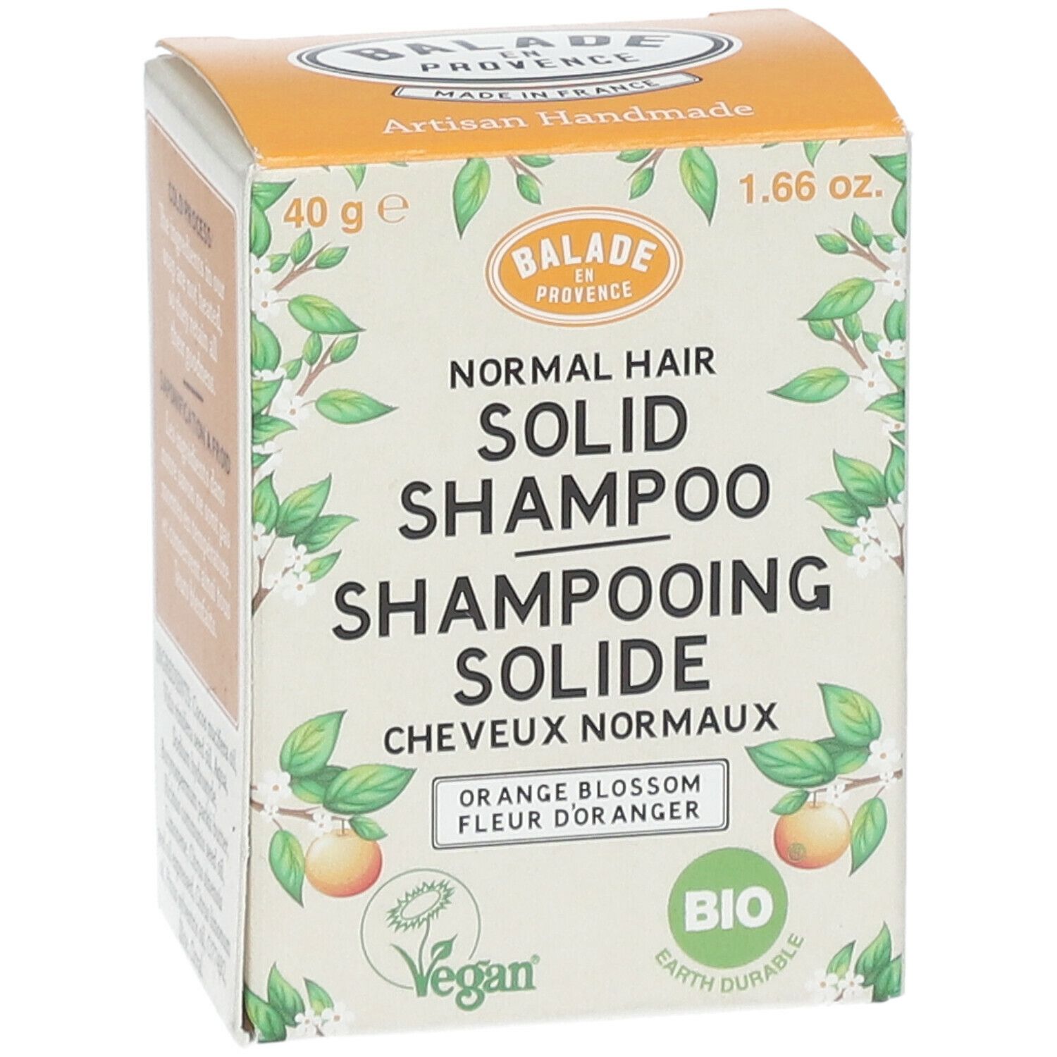 Voorkant van de shampoo verpakking. Productnaam, logo en Bio certificering. Oranje doos.