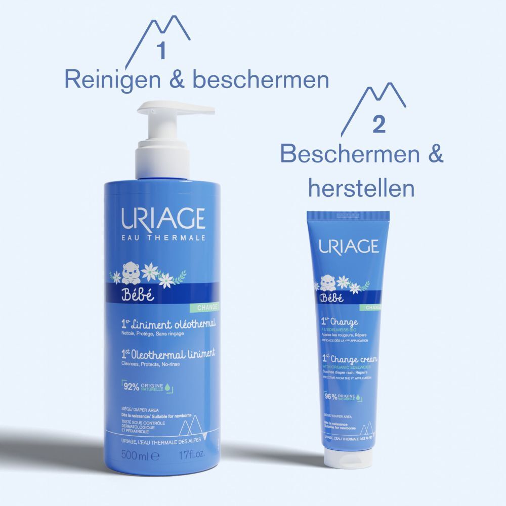 Twee blauwe flessen. URIAGE Bébé 1e Oleothermal Liniment en 1st Change Cream.