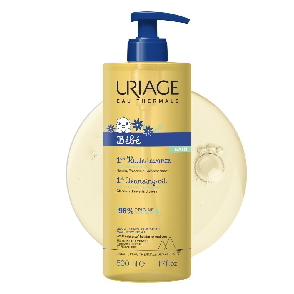Uriage Bébé 1ère Huile lavante. Flacon avec pompe bleue. Liquide jaune. Étiquette avec texte.