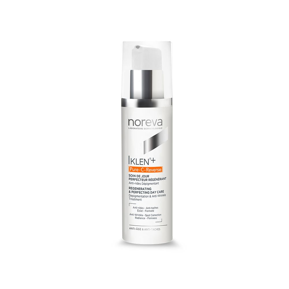 Witte fles met zilveren pomp. Tekst: Noreva, IKLEN+ Pure-C-Reverse, Regenerating & Perfecting Day Care.