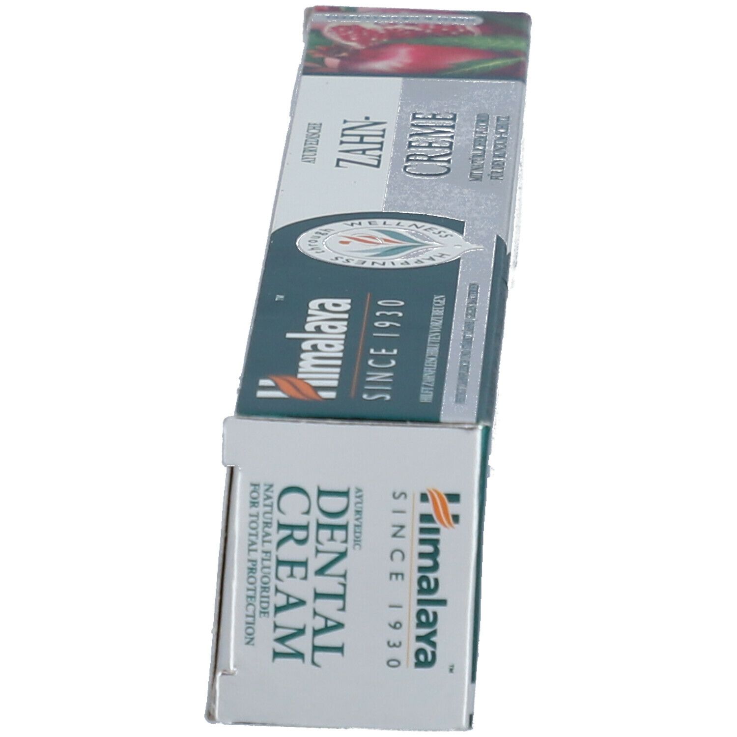 Schachtel, weiß, grün, rot. Text: Dental Cream, Himalaya. Abbildung von Granatapfel. Aufschrift: Zahncreme.
