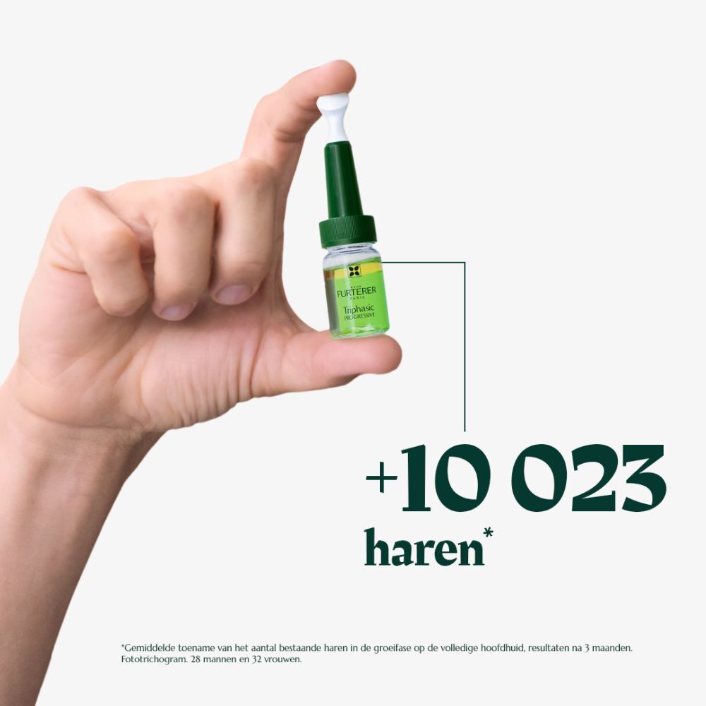 Hand houdt een ampul Triphasic Progressive vast. Tekst: +10 023 haren.