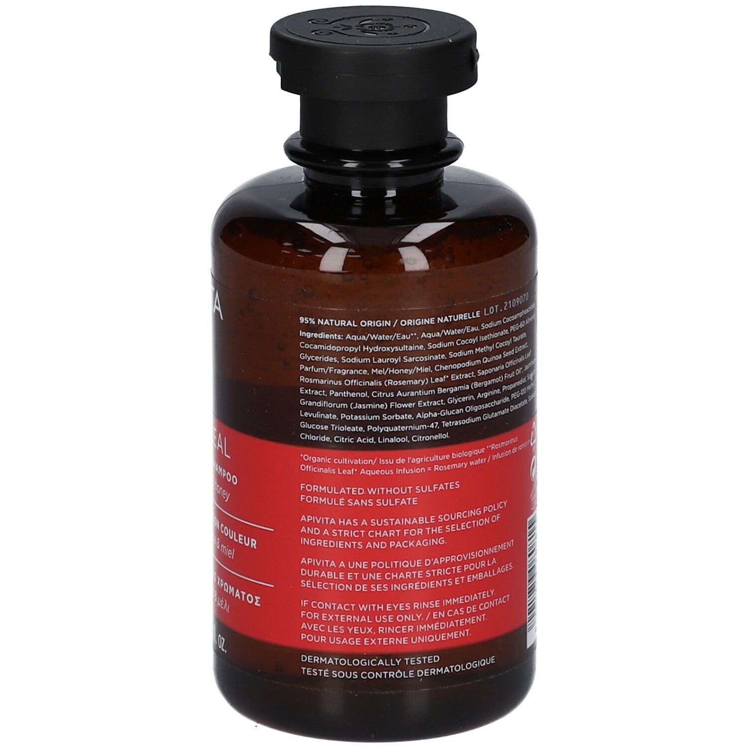Rückseite der braunen Flasche mit schwarzem Deckel. Rotes Etikett mit Text in mehreren Sprachen. Inhaltsstoffe.