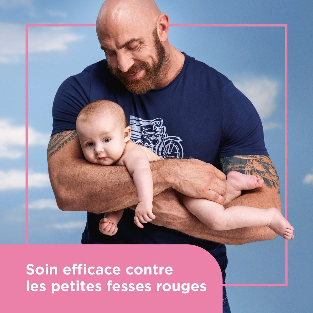 Image publicitaire. Un homme tient un bébé. Texte : Soin efficace contre les petites fesses rouges.