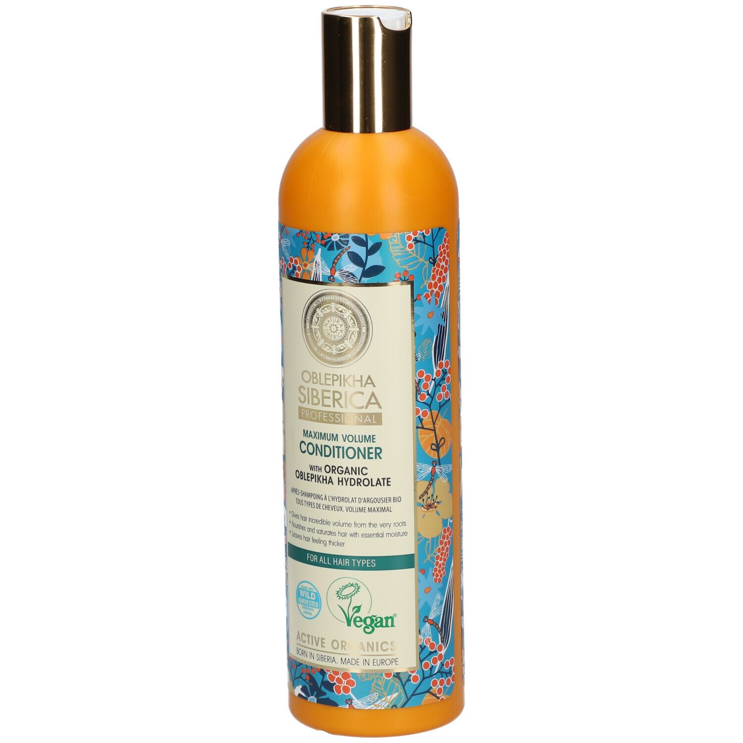 Oranje fles met gouden dop. Etiket met productnaam en bloemenpatroon. Veganistisch zegel.