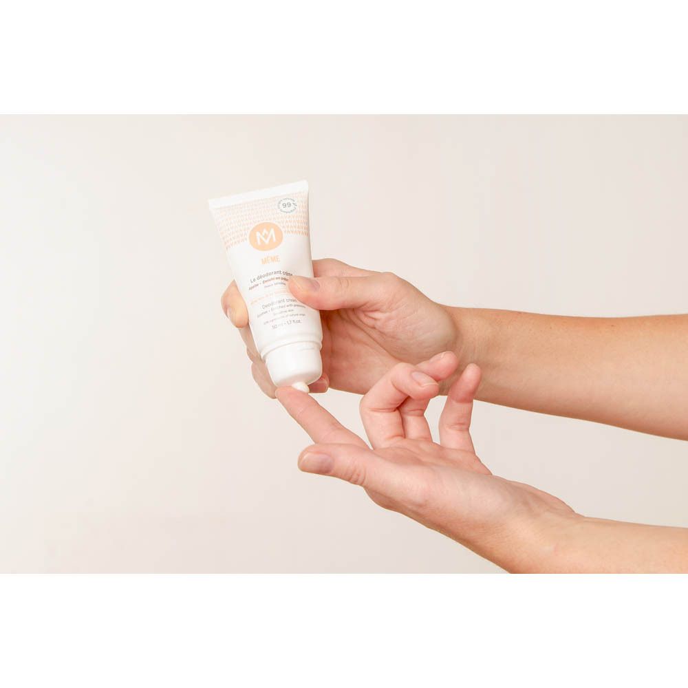 Persoon houdt crème deodorant tube vast. Crème op vingers. Toepassing.