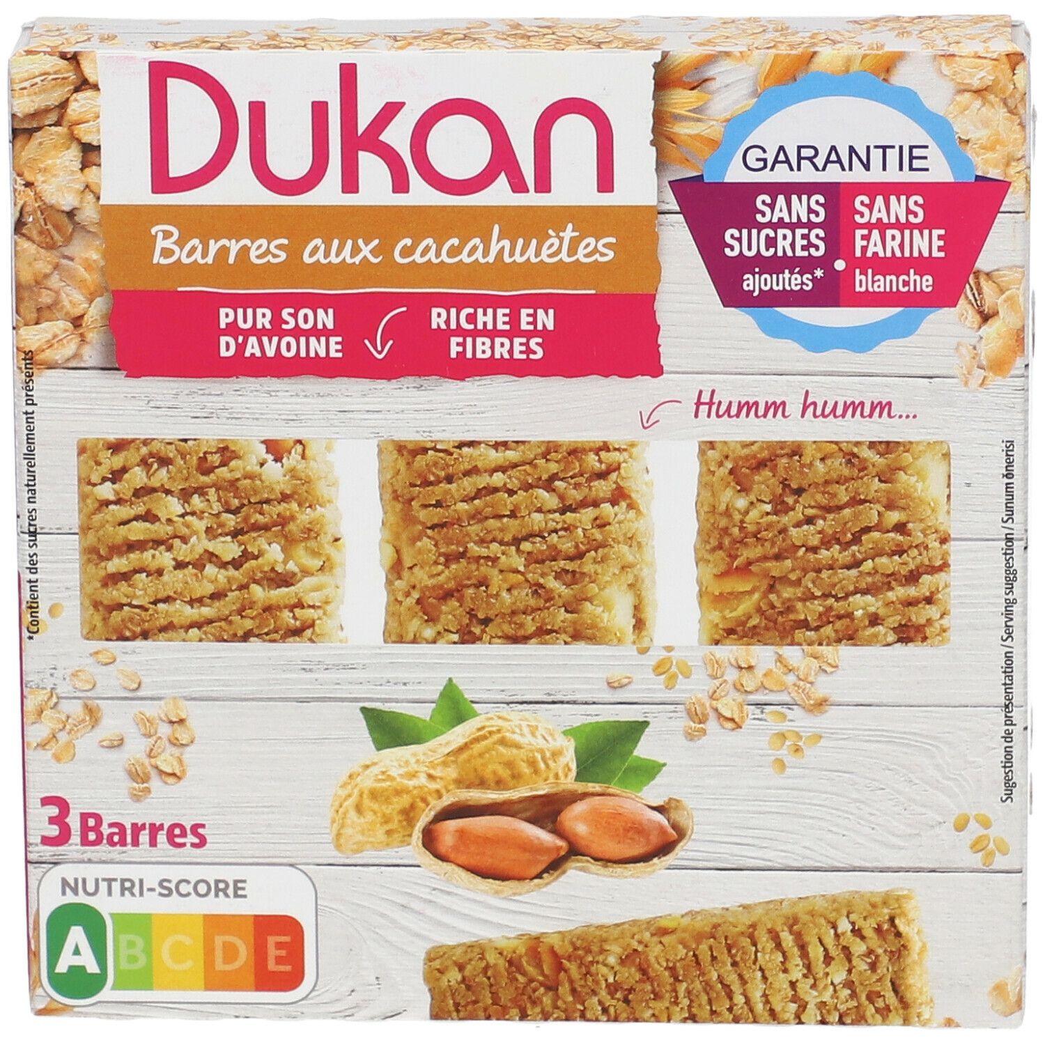 Dukan pinda reep verpakking. 3 repen, pinda's, havervlokken. Opschrift: Zonder toegevoegde suikers, zonder witte bloem. Nutri-Score beoordeling.