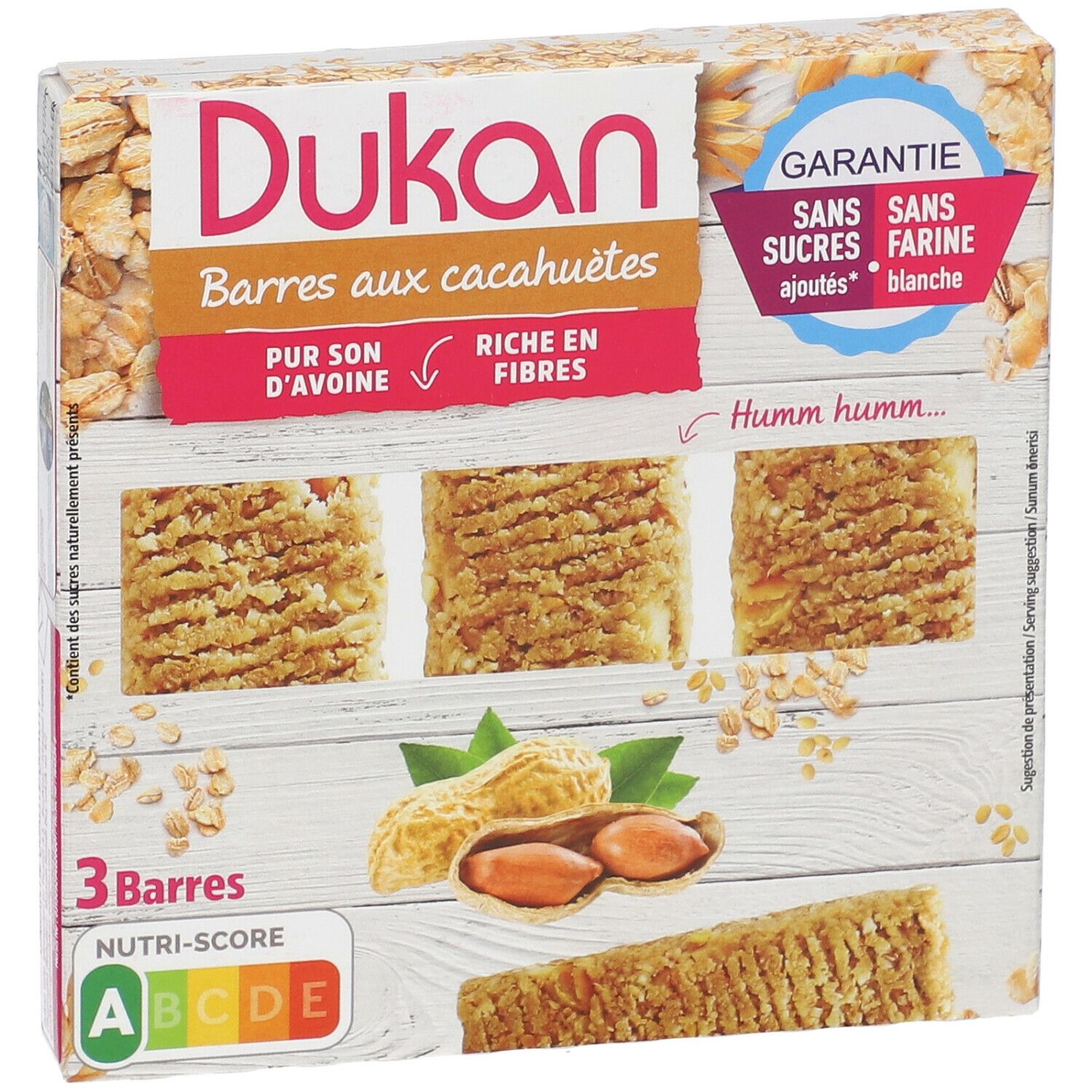 Dukan pinda reep verpakking. 3 repen, pinda's, havervlokken. Opschrift: Zonder toegevoegde suikers, zonder witte bloem. Nutri-Score beoordeling.