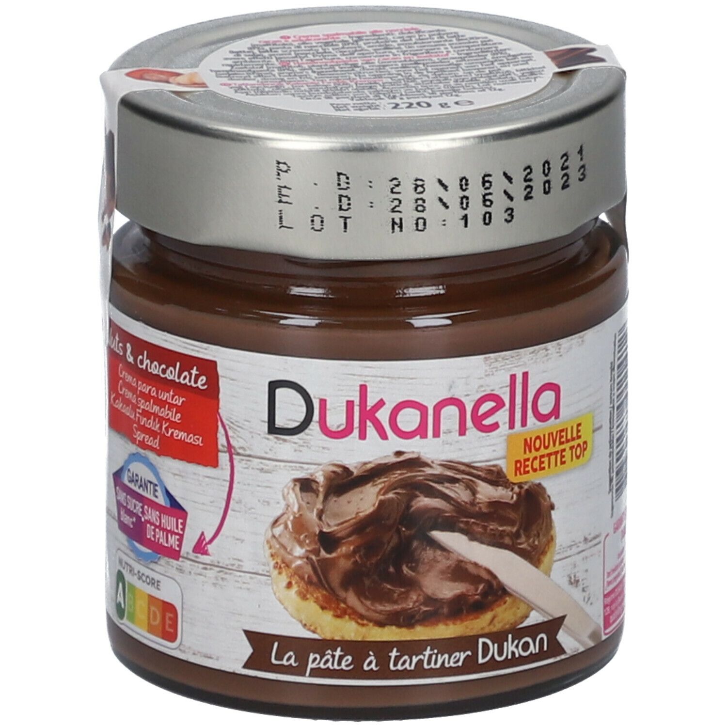 Pot chocoladecrème. Deksel met datums. Opschrift: Dukanella, Nouvelle Recette Top. Sticker met productafbeelding.