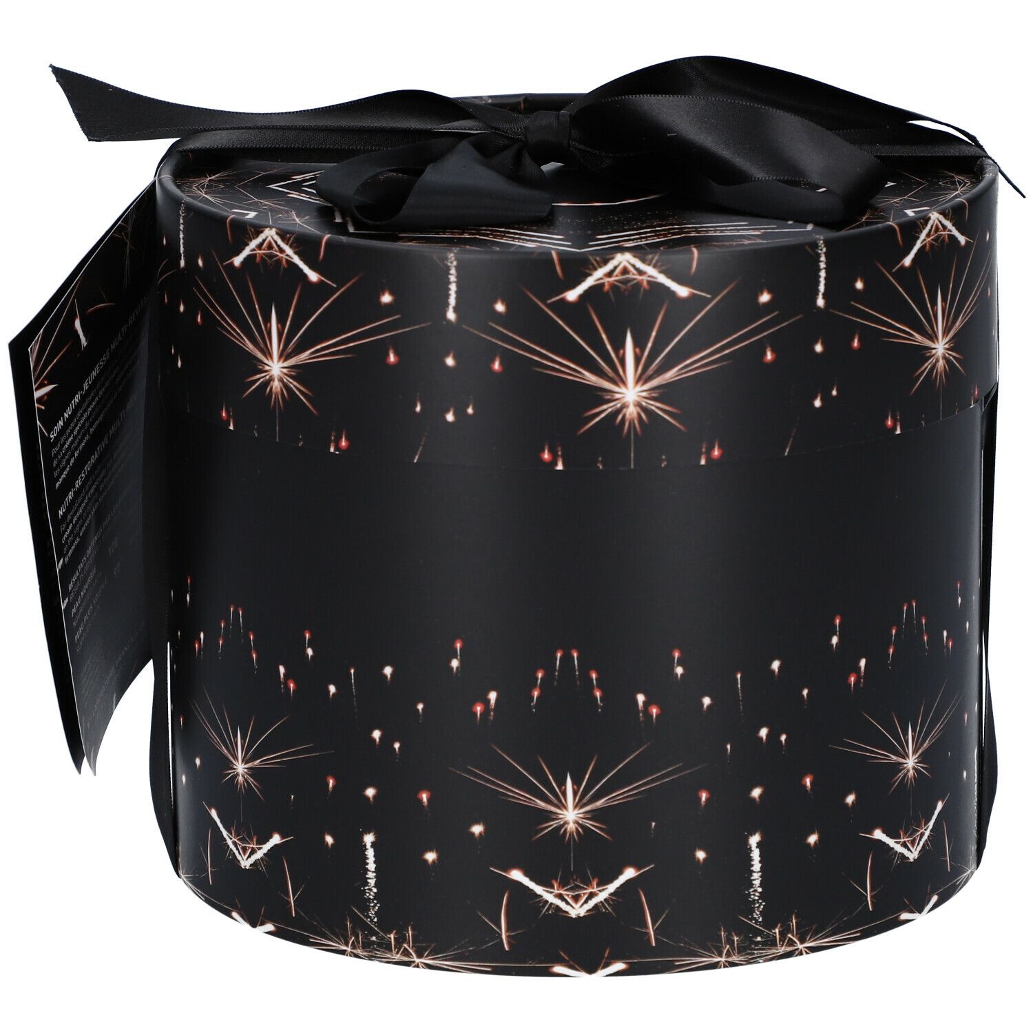 Zylindrische Geschenkbox mit schwarzem Band. Schwarzer Hintergrund mit goldenen Sternen. Aufschrift FILORGA PARIS. Etikett mit Produktinformationen.