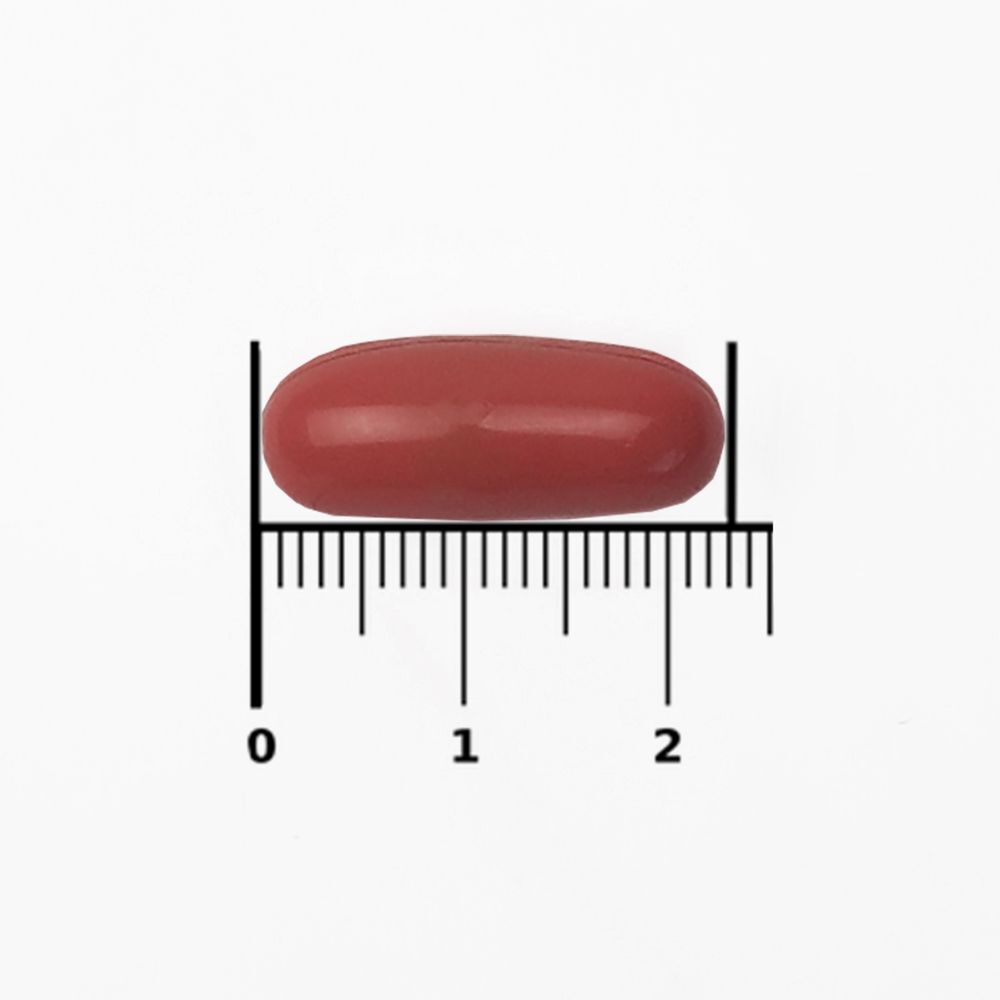 Enkele capsule. Roodachtige, ovale vorm. Geplaatst op een schaal.