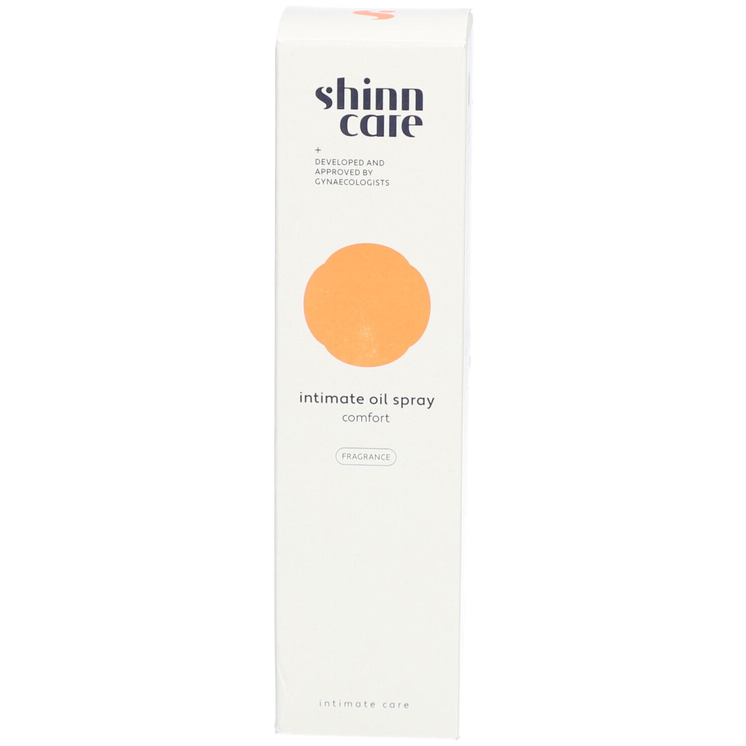 Weiße Schachtel mit orangefarbenem Kreis. Aufschrift: intimate oil spray comfort. Marke: shinn care.