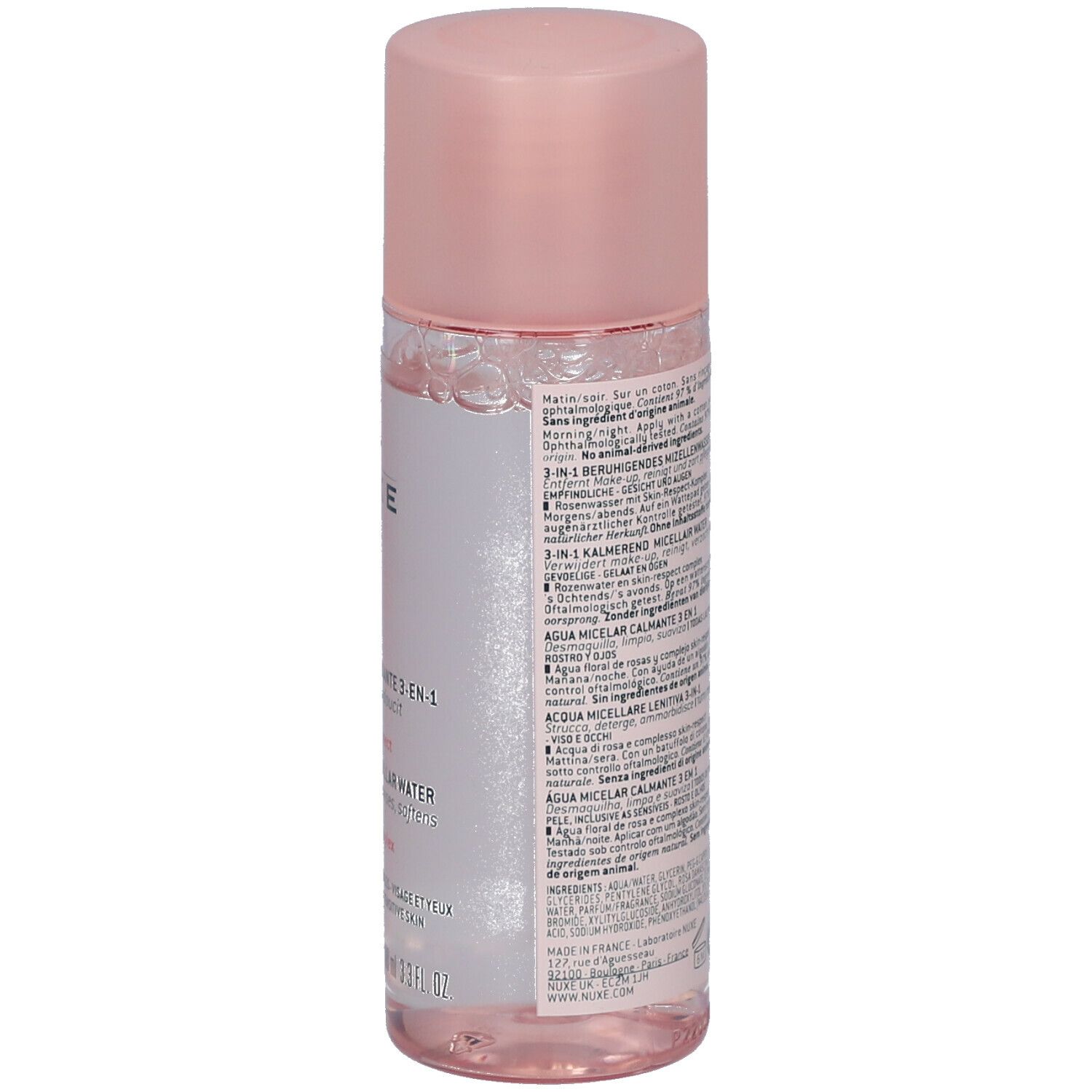 Flacon cylindrique avec liquide rose et bouchon rose. Étiquette avec texte. Vue de face.