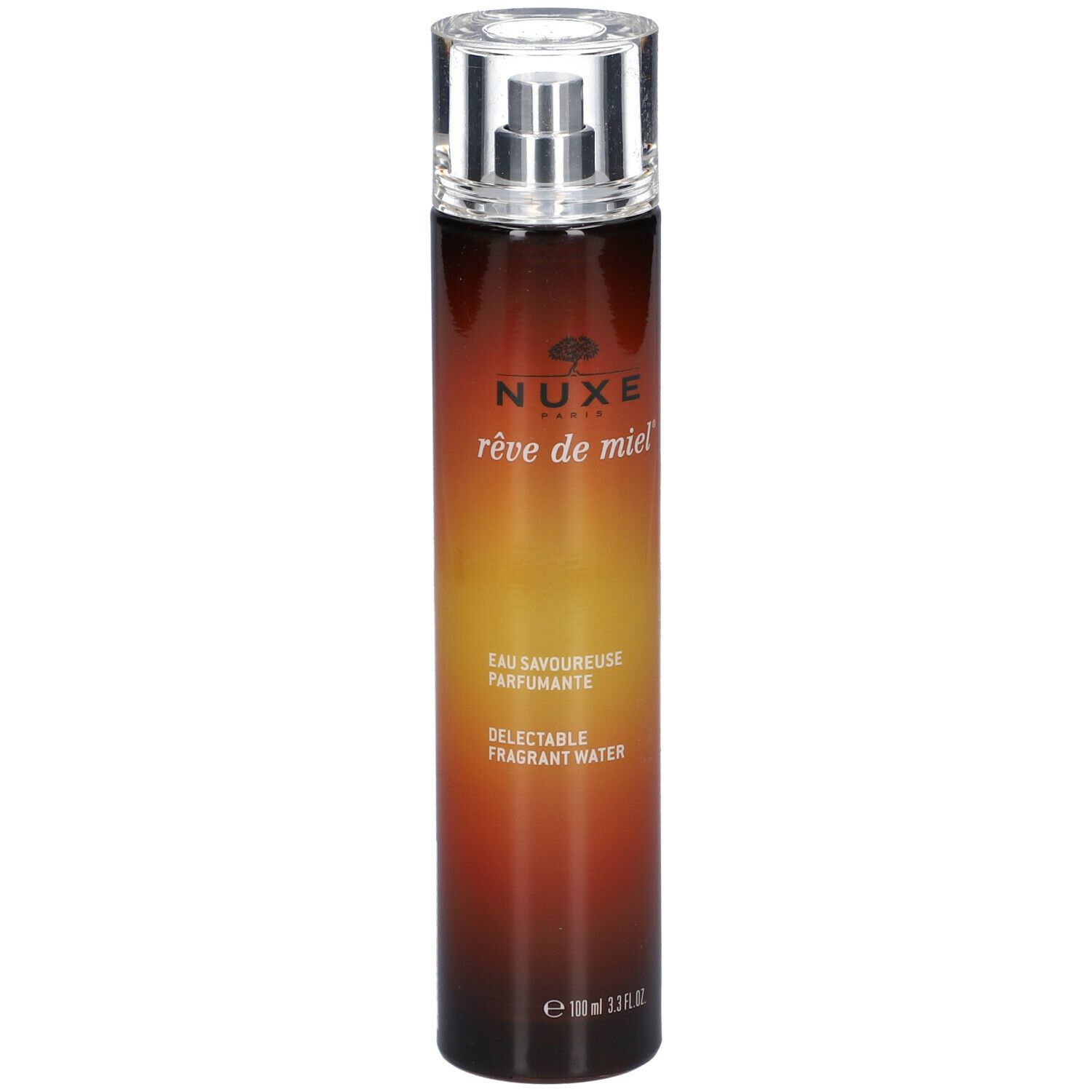 Cilindrische fles met verstuiver. Opschrift: Nuxe, rêve de miel, Eau Savoureuse Parfumante, Delectable Fragrant Water.
