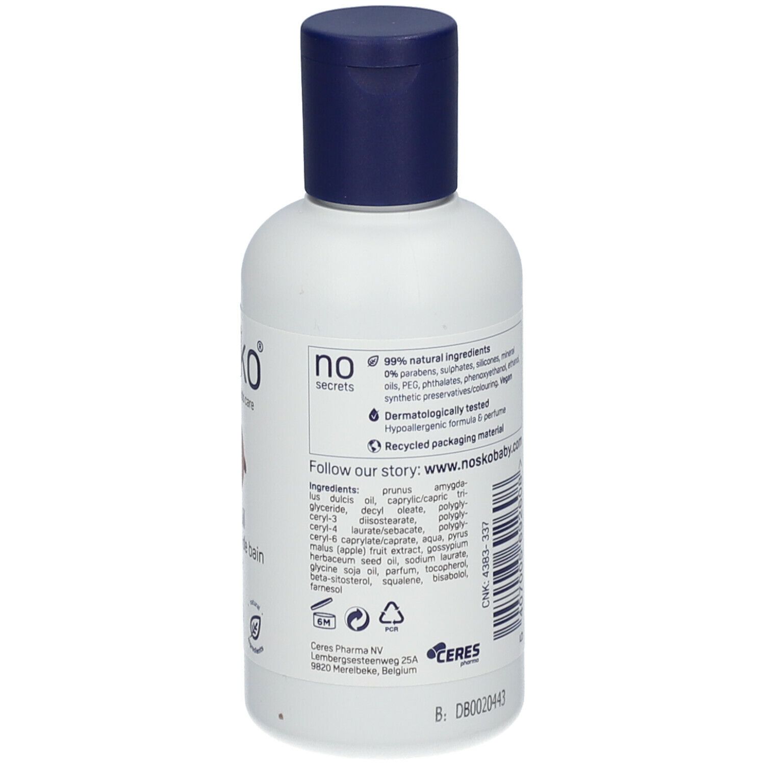 Achterkant van de witte fles met blauwe dop. Meertalige tekst. Opschrift: nosko, badolie. Tekst over ingrediënten en gebruik.