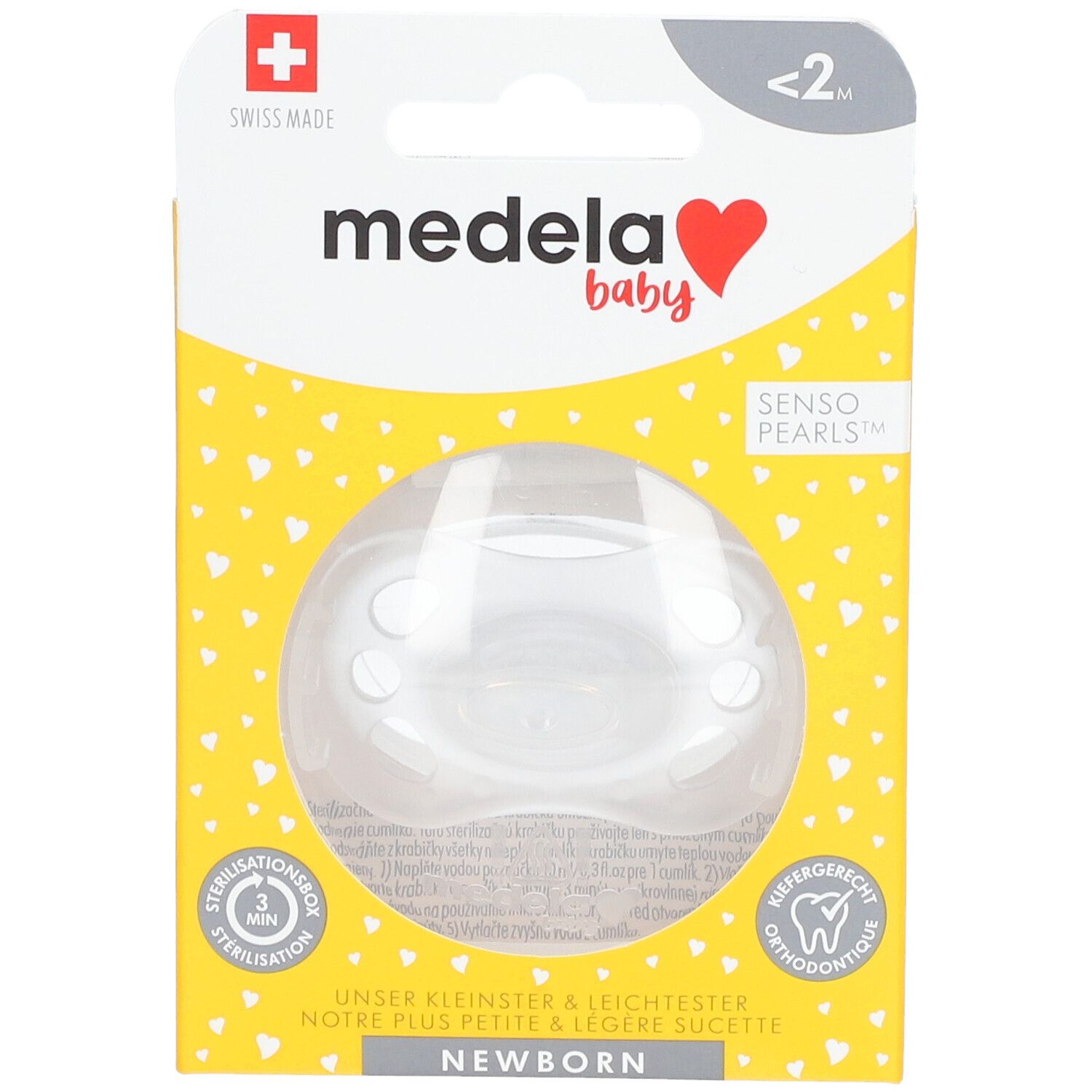 Emballage de sucette Medela Baby. Boîte jaune à motifs cœurs. Texte: Newborn, Senso Pearls. Vue du produit à travers une fenêtre.
