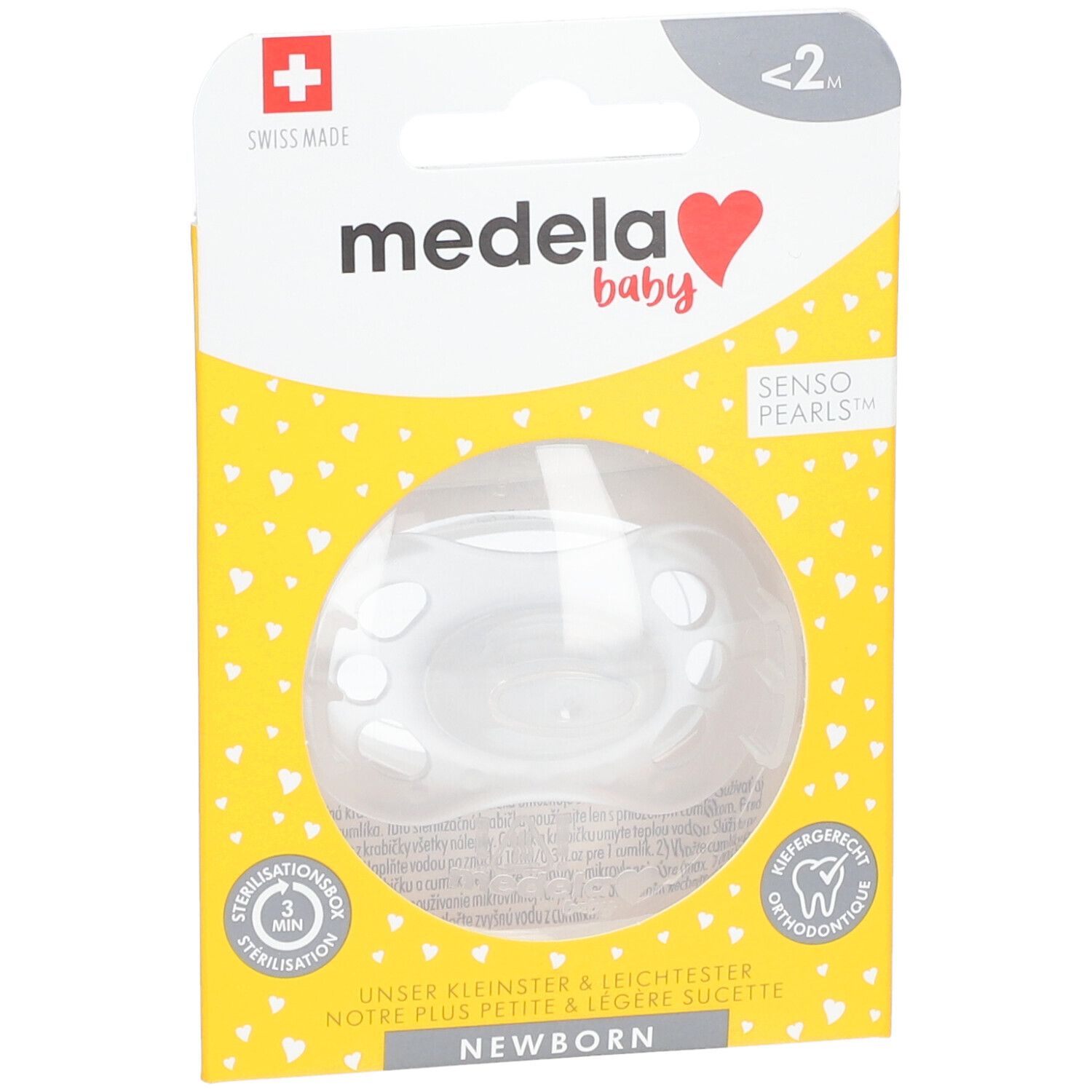 Emballage de sucette Medela Baby. Boîte jaune à motifs cœurs. Texte: Newborn, Senso Pearls. Vue du produit à travers une fenêtre.