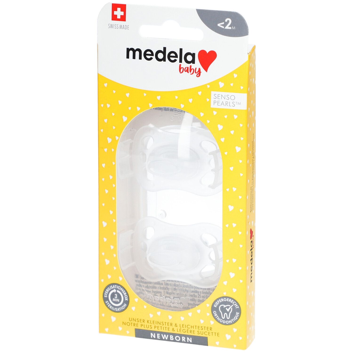 Emballage de deux tétines Medela Baby. Emballage jaune avec motifs de cœur et croix suisse.