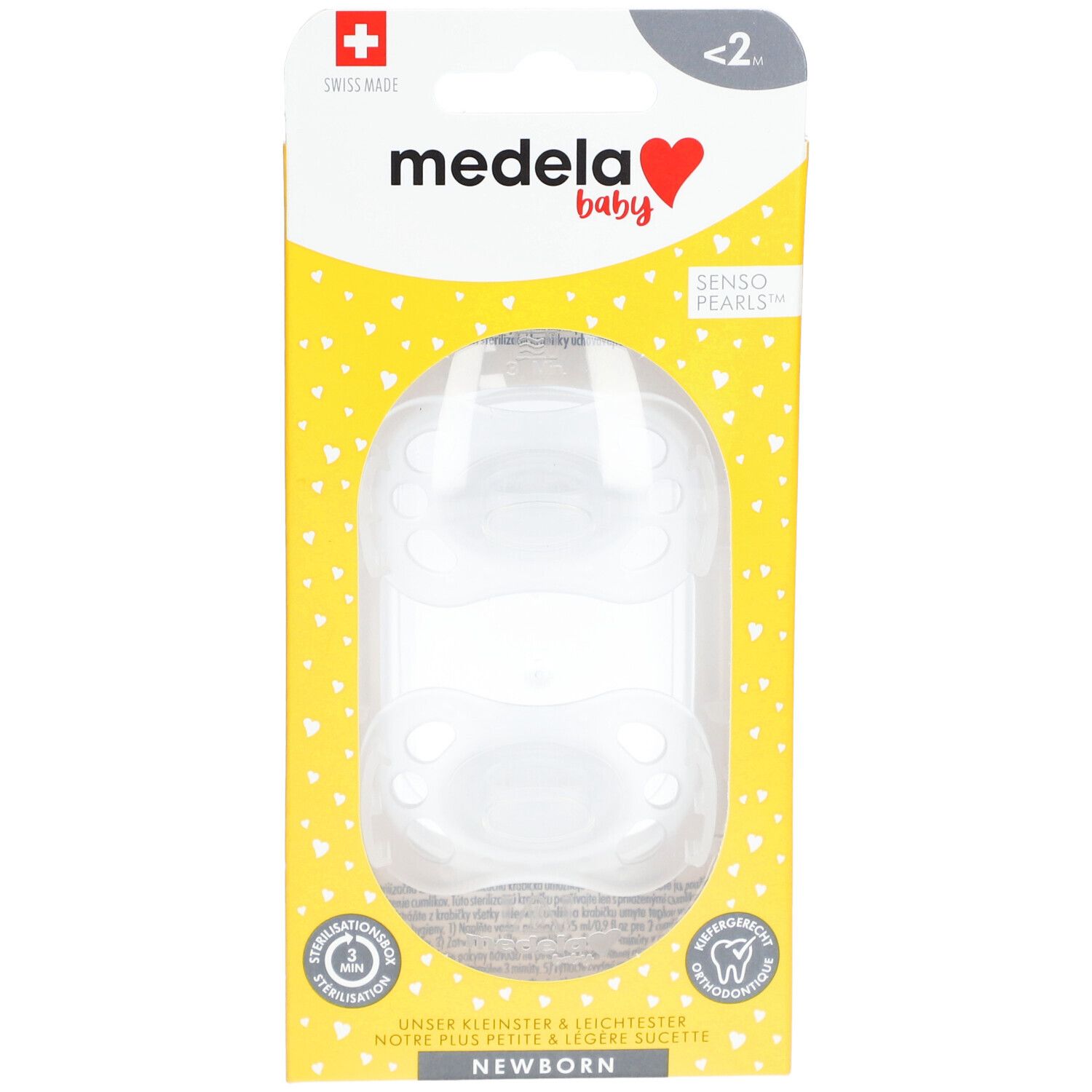 Deux tétines dans un emballage transparent. Emballage jaune avec logo Medela Baby et croix suisse.