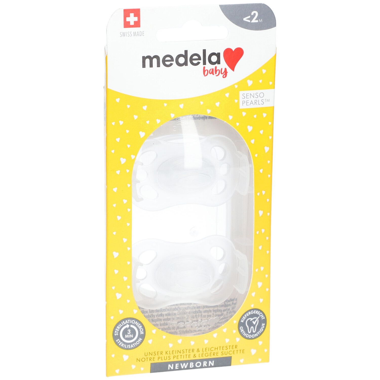 Deux tétines dans l'emballage. Emballage jaune avec logo Medela Baby et croix suisse.