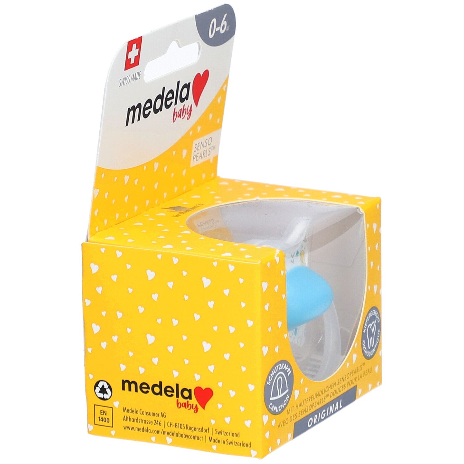 Sucette Medela Baby dans un emballage jaune. Tétine bleue visible. Recommandé pour 0-6 mois. Croix suisse.