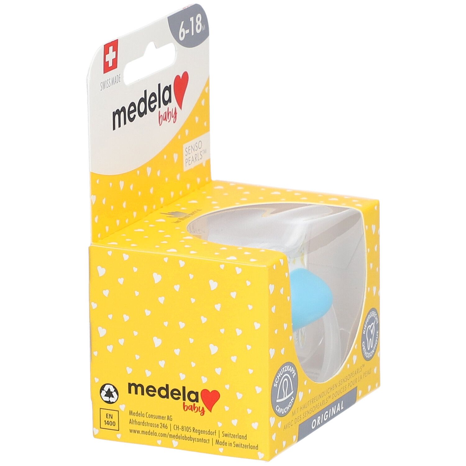 Sucette Medela Baby dans emballage. Turquoise, 6-18 mois. Fenêtre transparente. Boîte jaune à motifs cœurs.