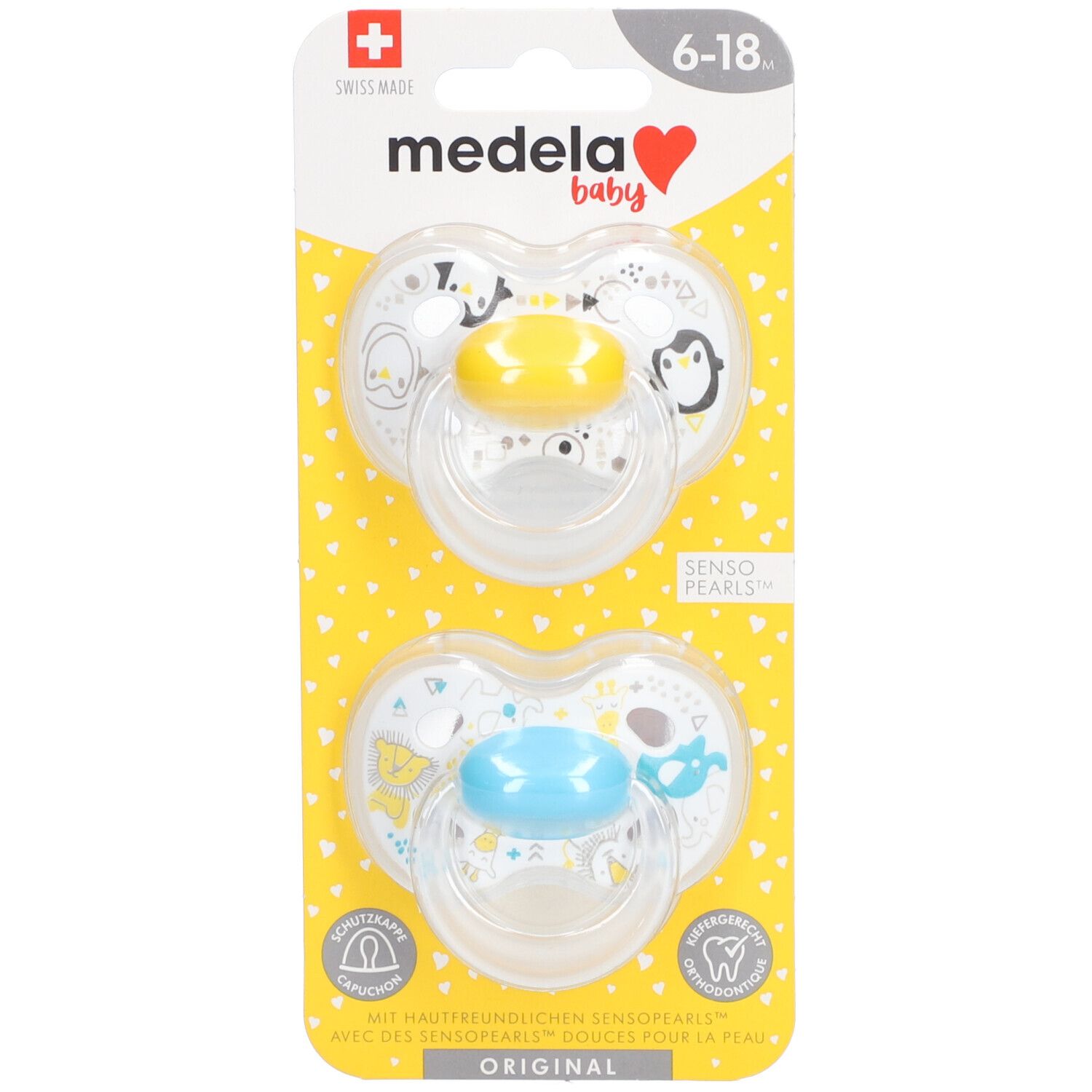 Zwei Schnuller mit gelben und blauen Saugern. Auf gelber Karte mit Herzmuster. Marke Medela Baby, 6-18 Monate.