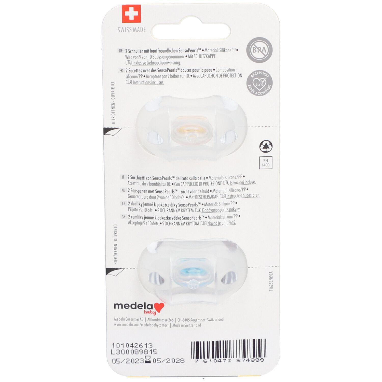 Rückseite der Verpackung mit zwei Schnullern. Text in Deutsch, Französisch, Italienisch und Niederländisch. Marke Medela Baby.