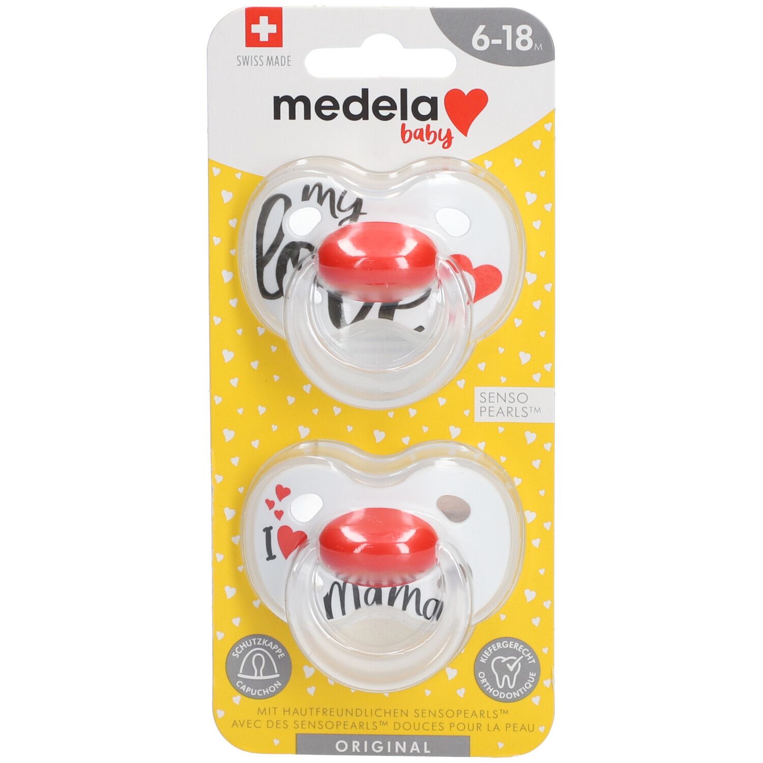 Zwei Schnuller in Herzform auf Verpackung. Roter Sauger, transparente Basis. Aufdruck: "love", "I love mama". Altersempfehlung: 6-18 Monate.