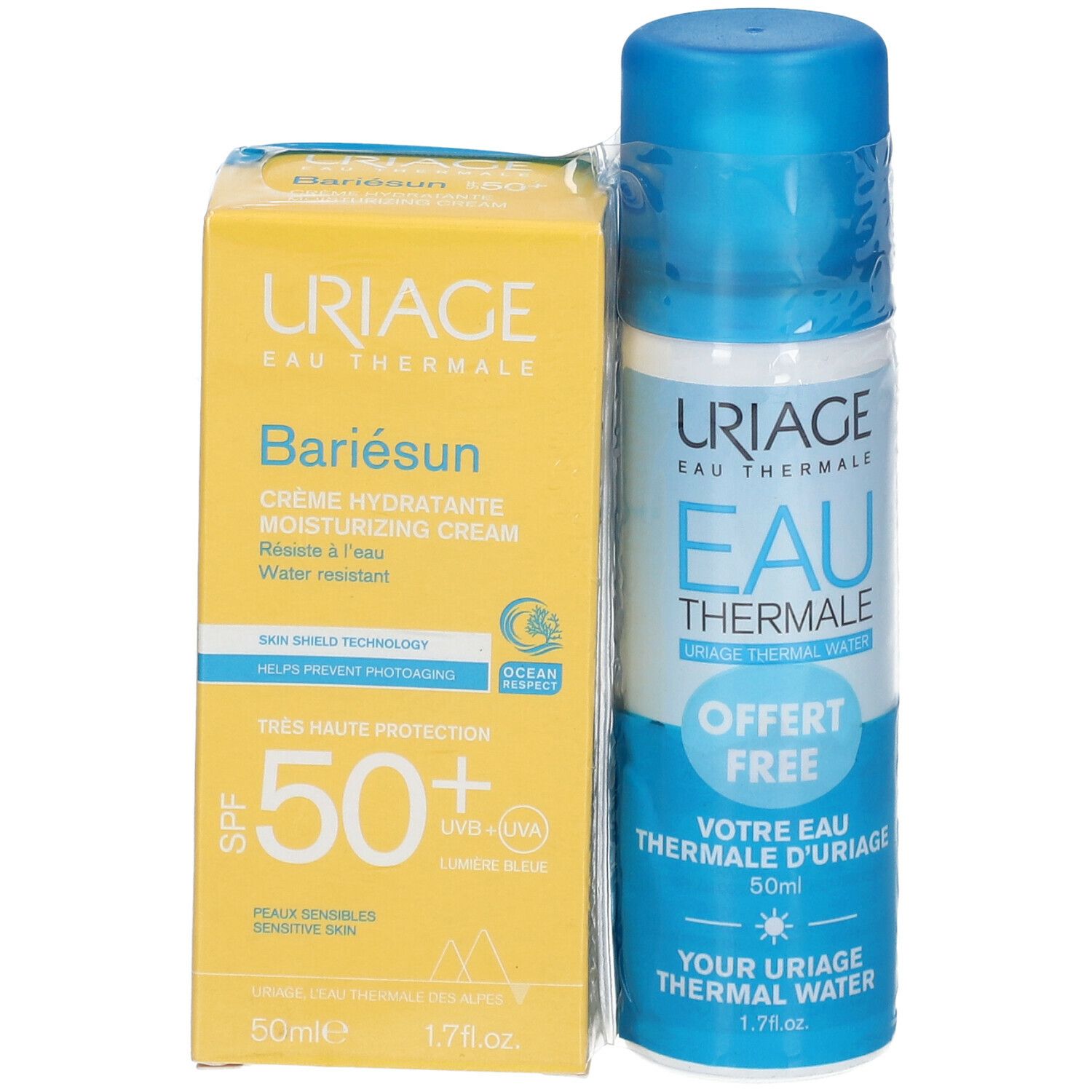 Gelbe Schachtel und blaue Sprühflasche. Auf der Schachtel steht "URIAGE Bariésun". Auf der Flasche steht "EAU THERMALE".