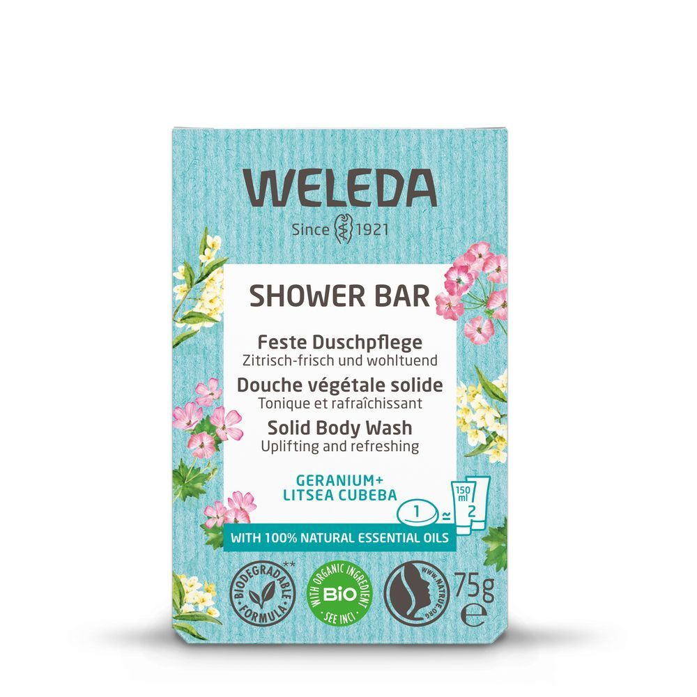 Lichtblauwe verpakking voor douchezeep Geranium + Litsea cubeba. Met bloemen en productinfo.