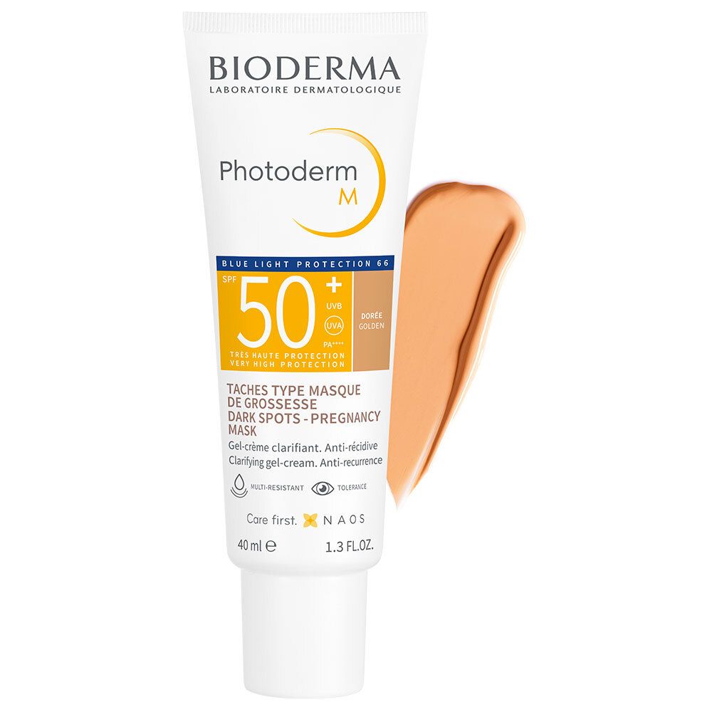 Tube BIODERMA Photoderm M en kleurstalen. Geelbruine kleur. Tekst met SPF50+ en productnaam.
