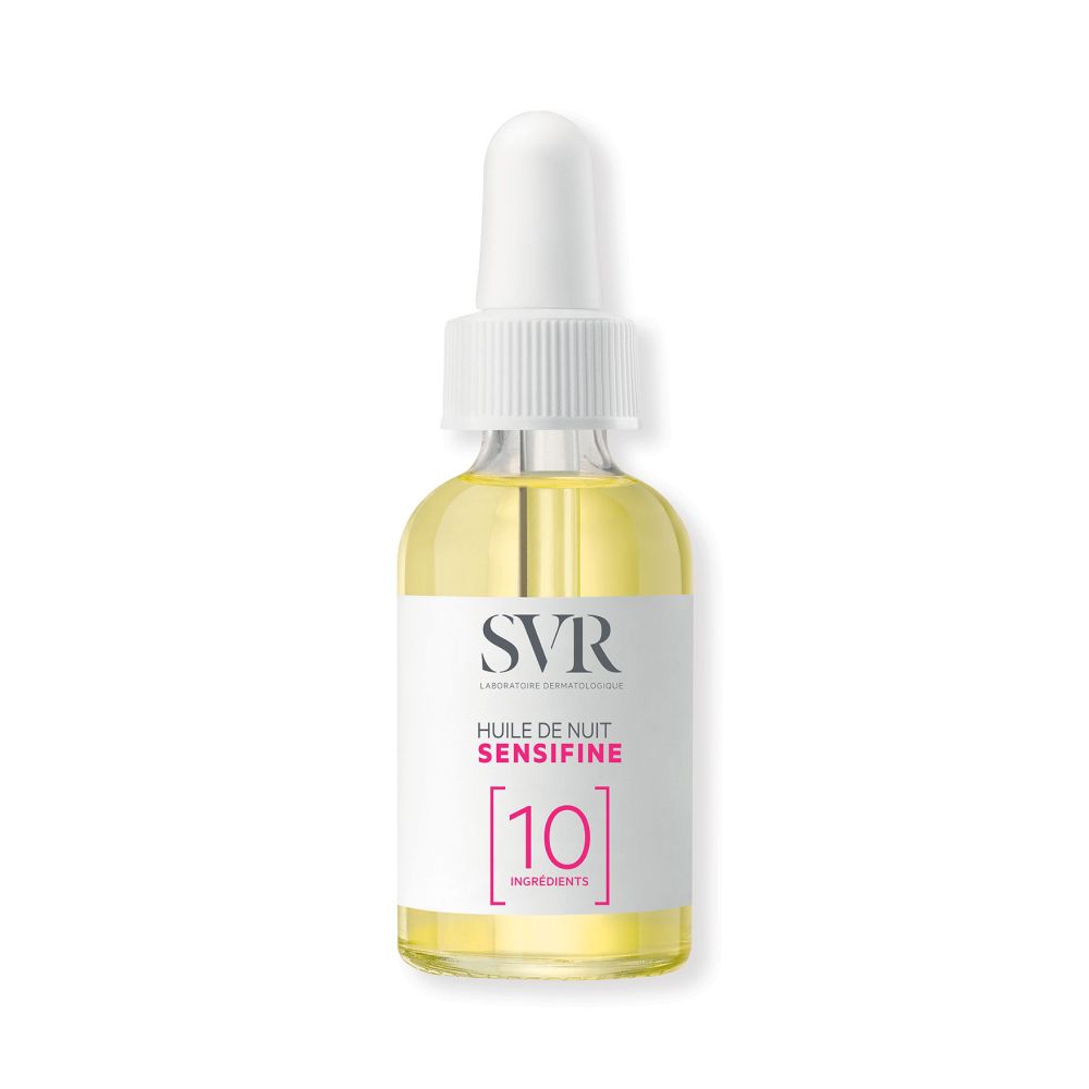 Glazen fles met pipet, gevuld met gele olie. Label: SVR, Huile de Nuit Sensifine, 10 Ingredients.