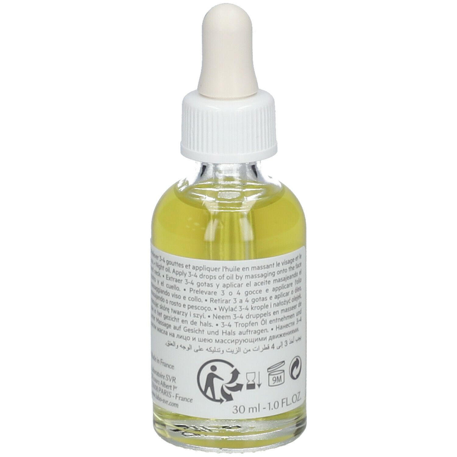 Glazen fles met pipet, gevuld met gele olie. Label: SVR, Huile de Nuit Sensifine, 10 Ingredients. Tekst op achterkant.