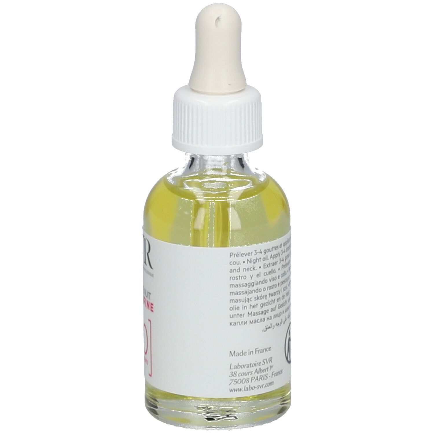 Glazen fles met pipet, gevuld met gele olie. Label: SVR, Huile de Nuit Sensifine, 10 Ingredients. Tekst op achterkant.