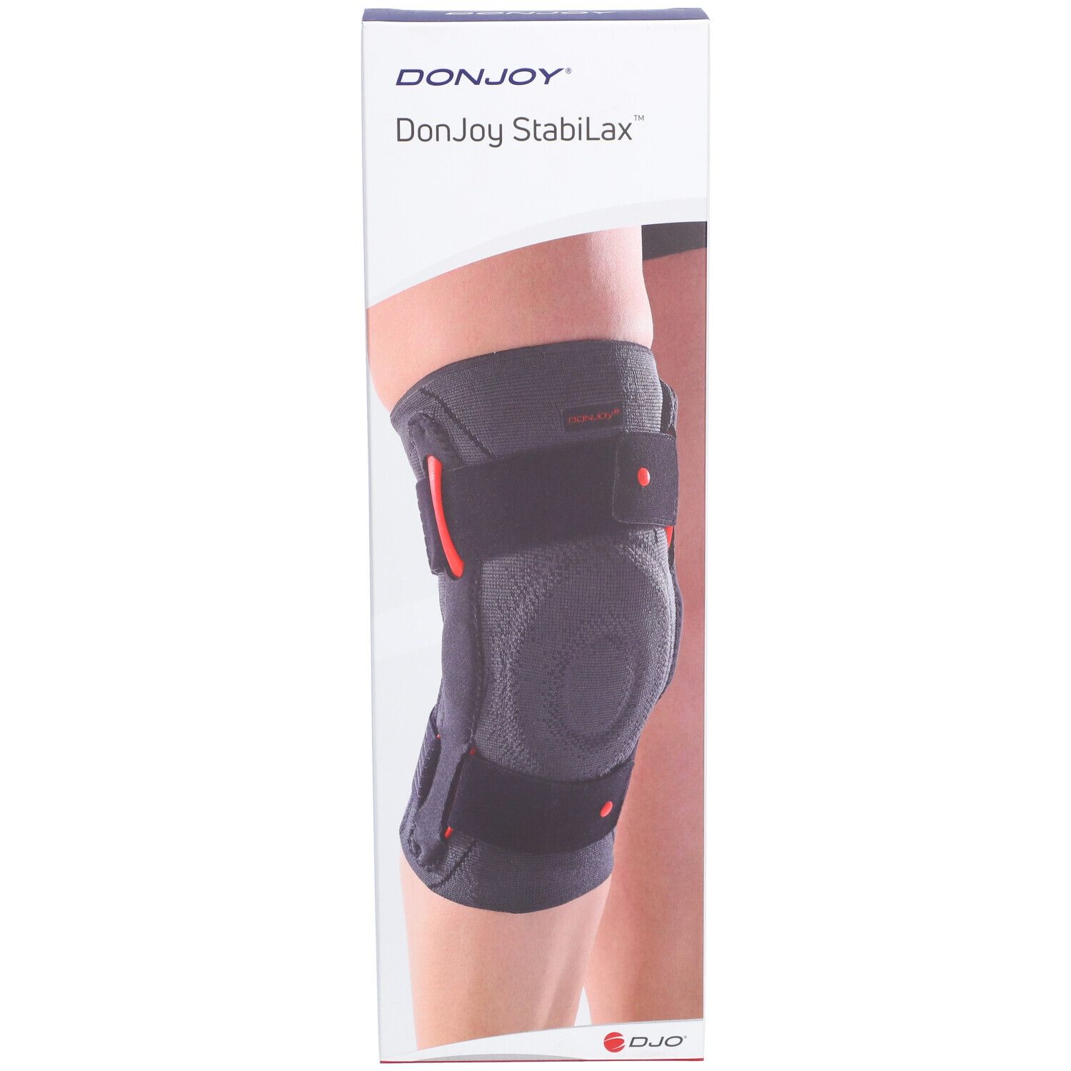 Genouillère DonJoy StabiLax dans son emballage. Bandage gris avec détails rouges et fermetures velcro. Inscription : DonJoy StabiLax.