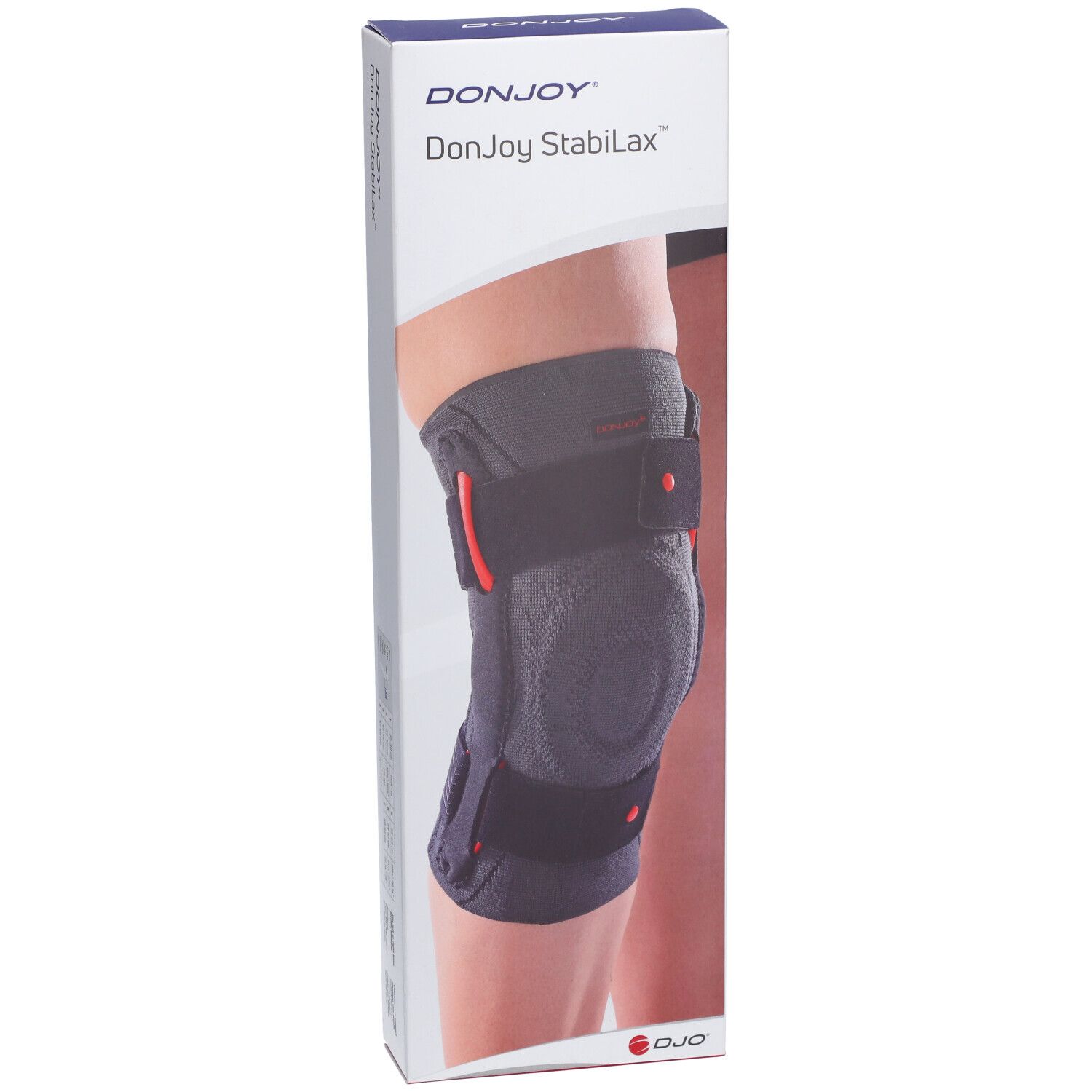 Genouillère DonJoy StabiLax dans son emballage. Noire, avec des détails rouges. Portée sur une jambe.