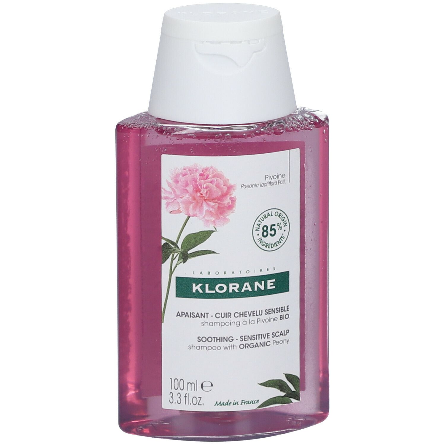 Flasche KLORANE Shampoo mit Pfingstrose BIO. Rosa Flüssigkeit, weißer Deckel. Etikett mit Blüte und Text.