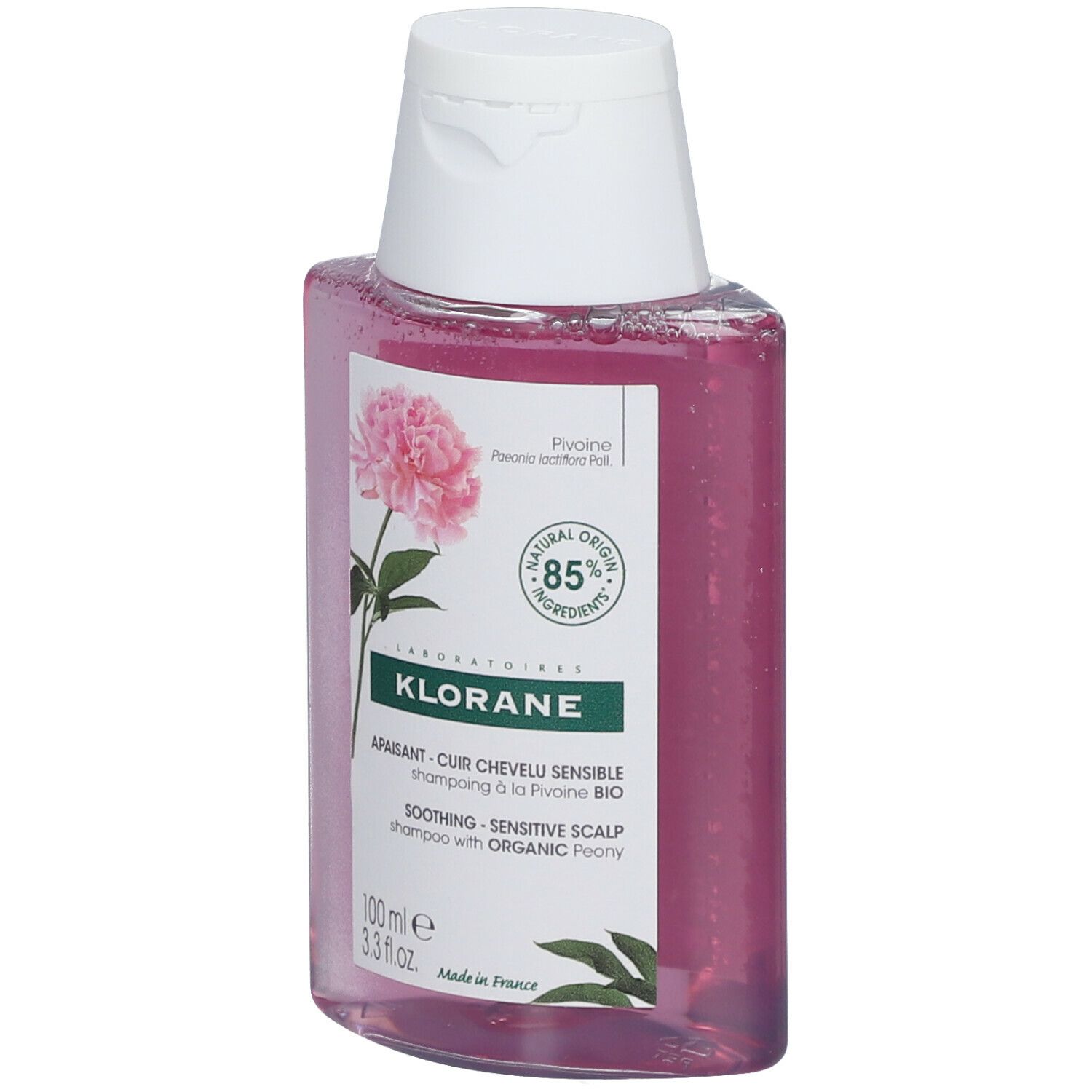 Flasche KLORANE Shampoo mit Pfingstrose BIO. Rosa Flüssigkeit, weißer Deckel. Etikett mit Blüte und Text.