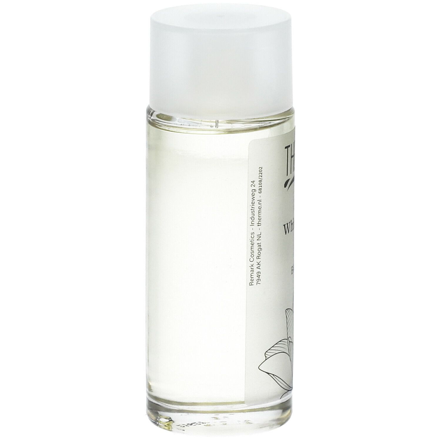 Glazen fles met witte dop. Opschrift: THERME Zen White Lotus BATH OIL. Achterkant met tekst en lotusbloem illustratie.
