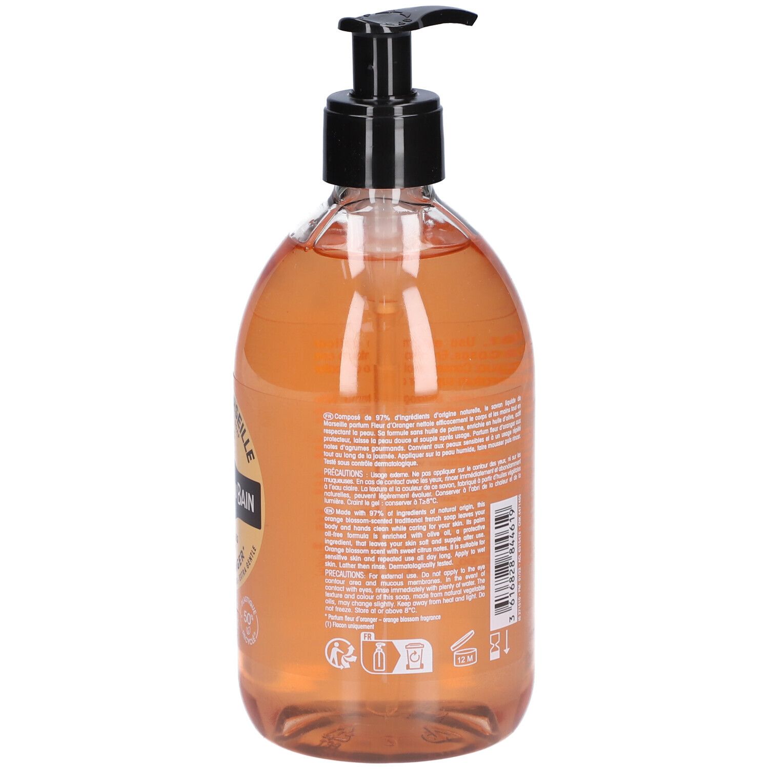 Rückseite der Seifenflasche. Text auf Etikett. Schwarzer Pumpkopf. Transparente Flasche mit orangefarbener Flüssigkeit.