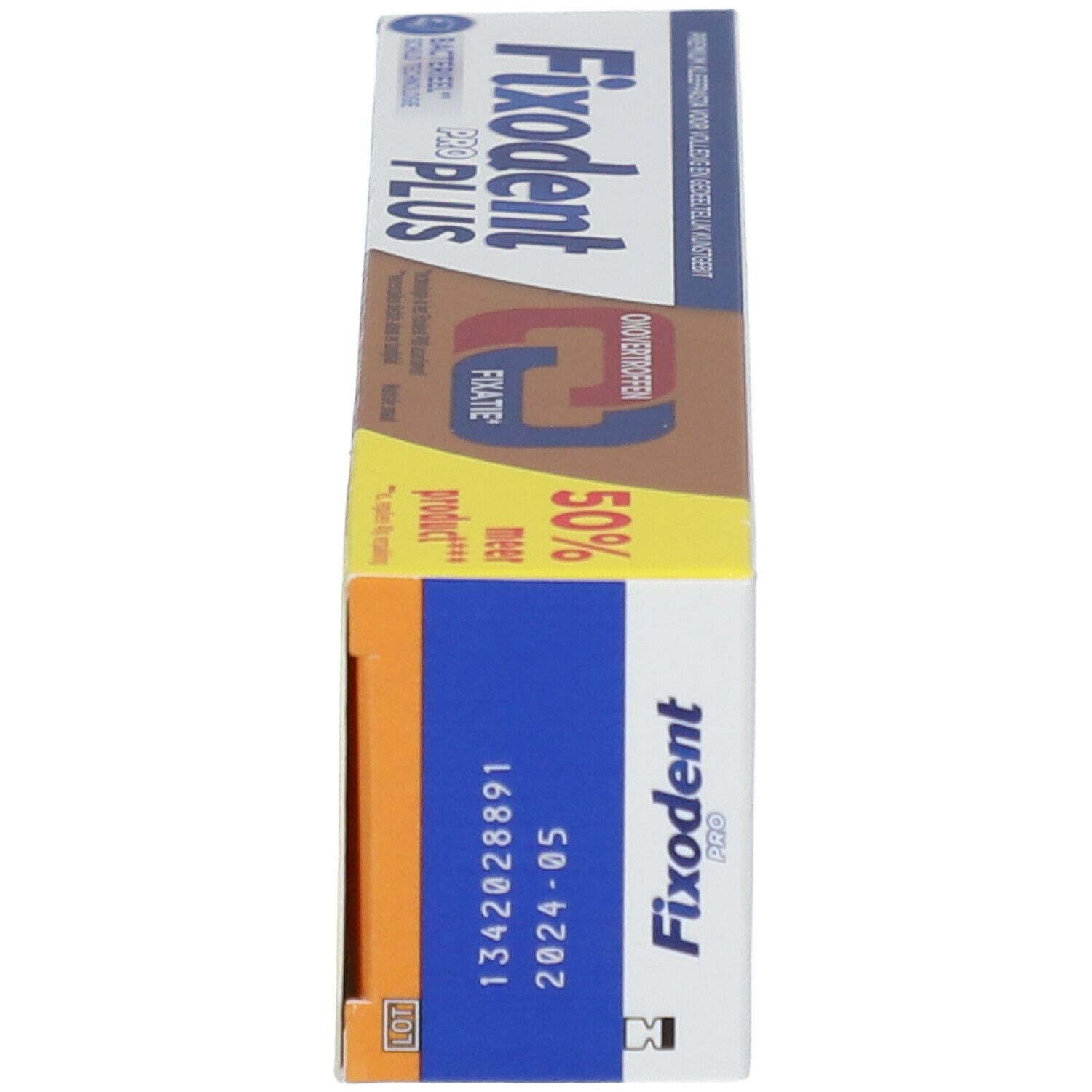 Fixodent Pro Plus verpakking, zijaanzicht. Blauw, oranje, wit. Houdbaarheidsdatum zichtbaar.
