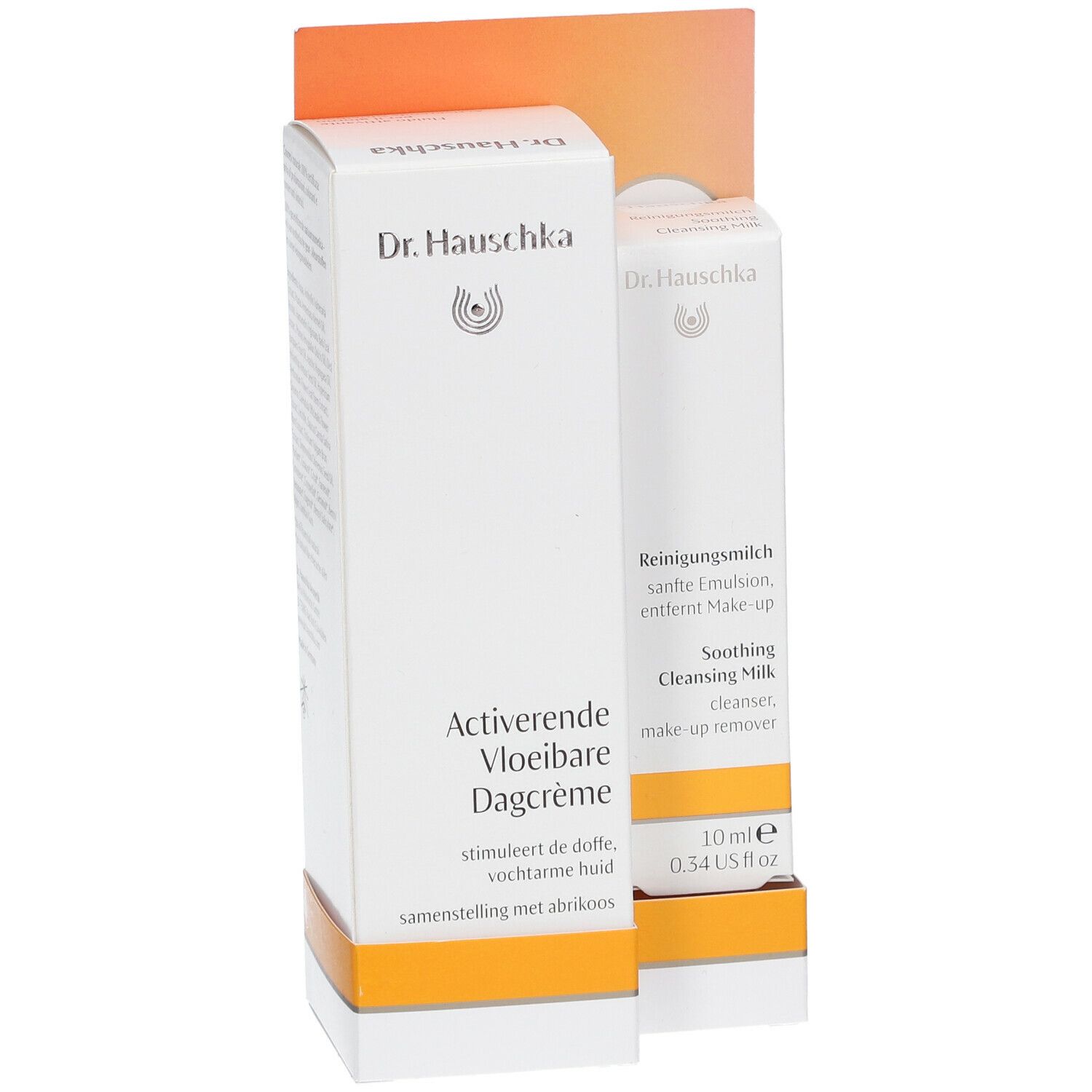 Twee Dr. Hauschka productverpakkingen. Eén doos met "Aktivierende Vloeibare Dagcrème", de andere met "Reinigingsmelk".