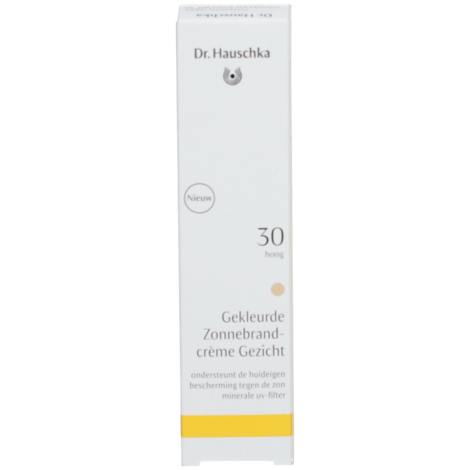 Weiße Schachtel mit Aufschrift: Dr. Hauschka, 30, getönte Sonnencreme für das Gesicht. Gelber Streifen unten.