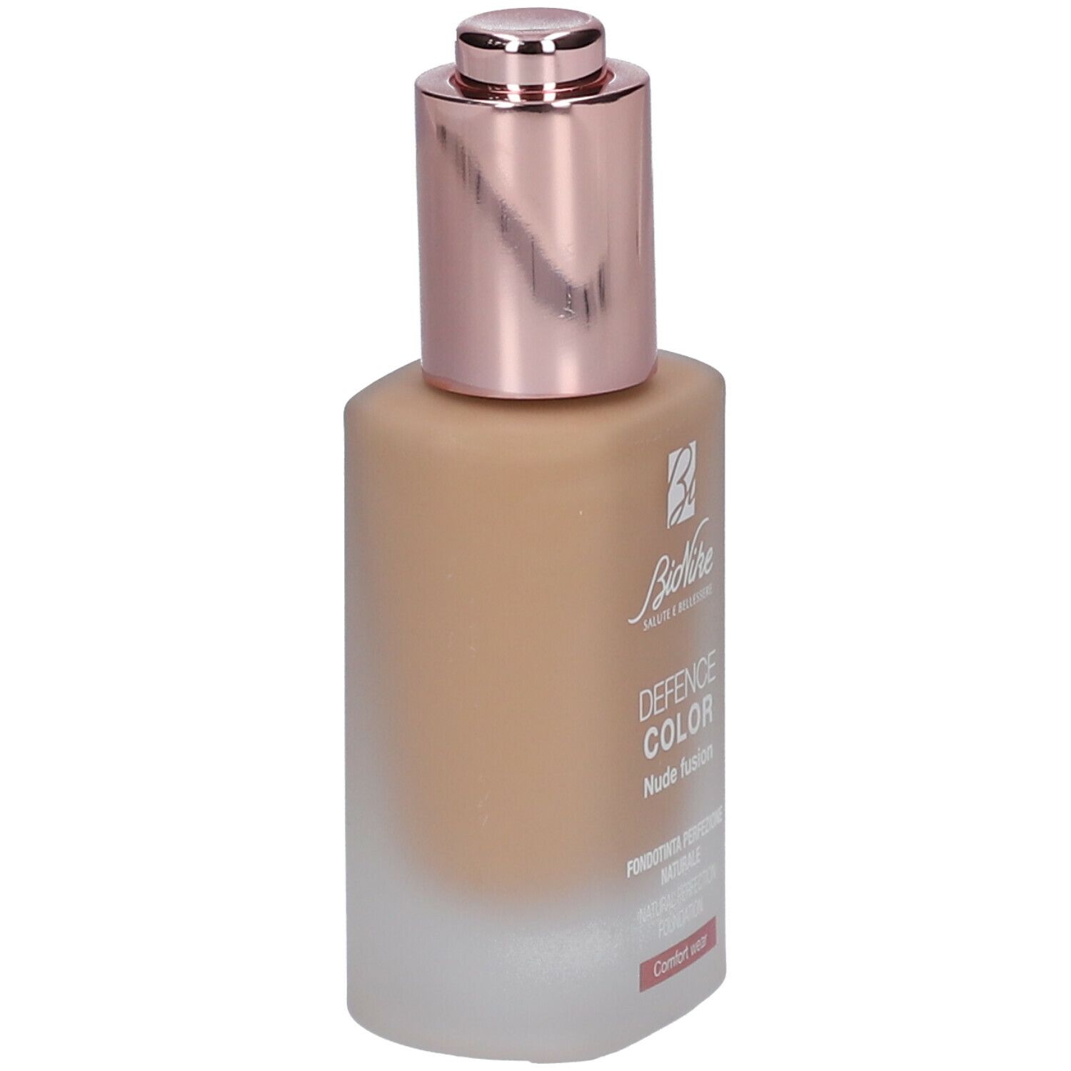 Foundationfles met roségouden dop. Opschrift: DEFENCE COLOR Nude fusion. Lichtbruine inhoud.