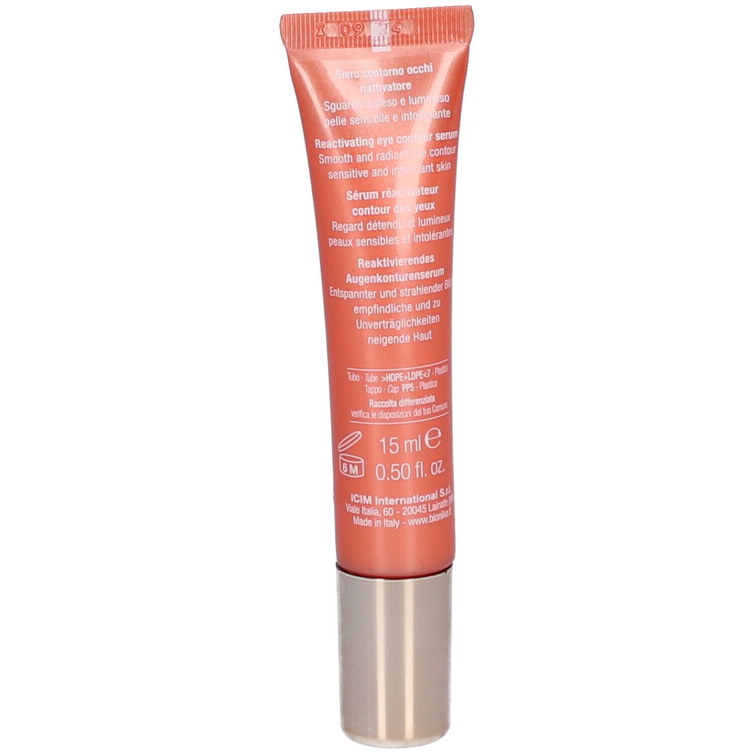 Rückseite der Tube mit Produktinformationen. Text in mehreren Sprachen. Orangefarbene Tube mit silberfarbenem Deckel.
