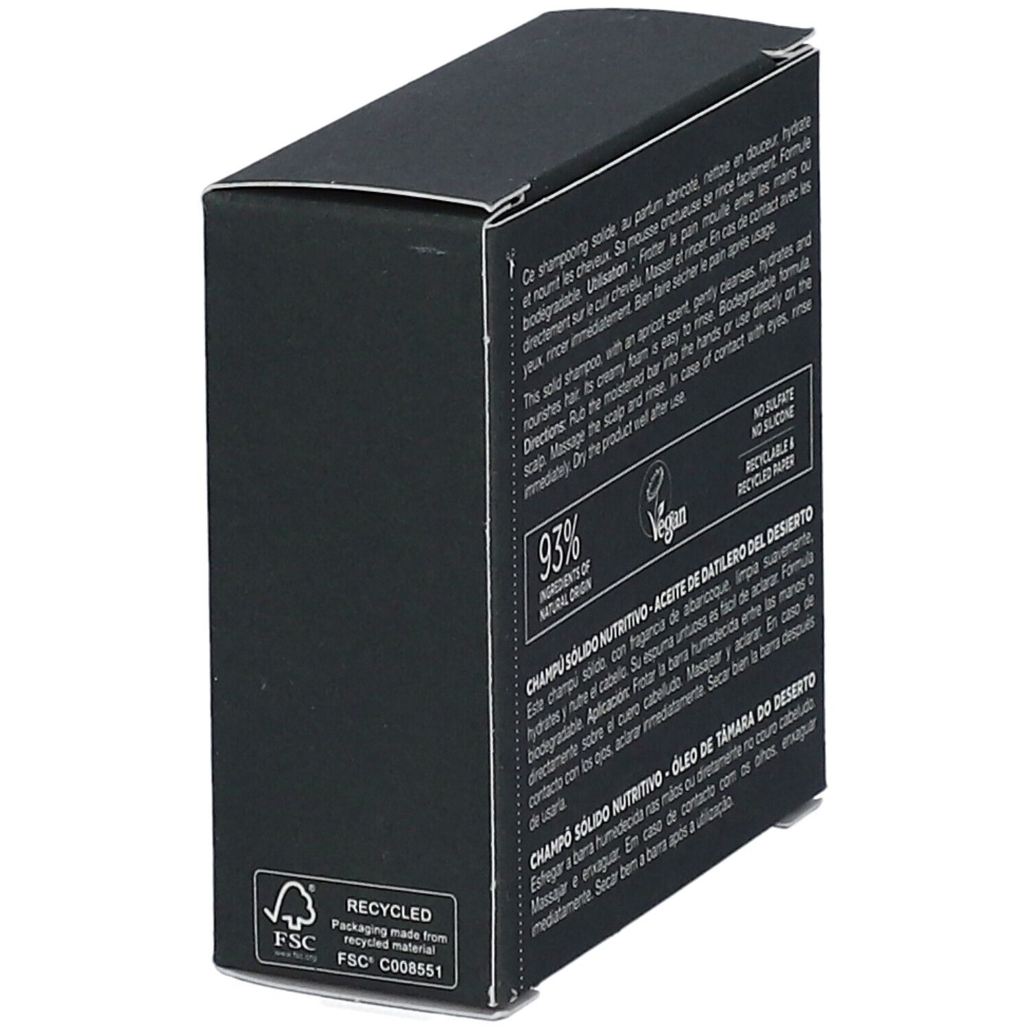 Rückseite einer schwarzen Schachtel. Text in mehreren Sprachen. Enthält Informationen über das feste Shampoo und Inhaltsstoffe.
